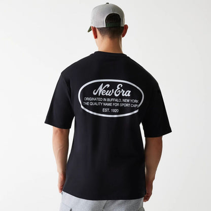 The Male model is wearing New Era Trucker Patch Black Oversized T-Shirt 2