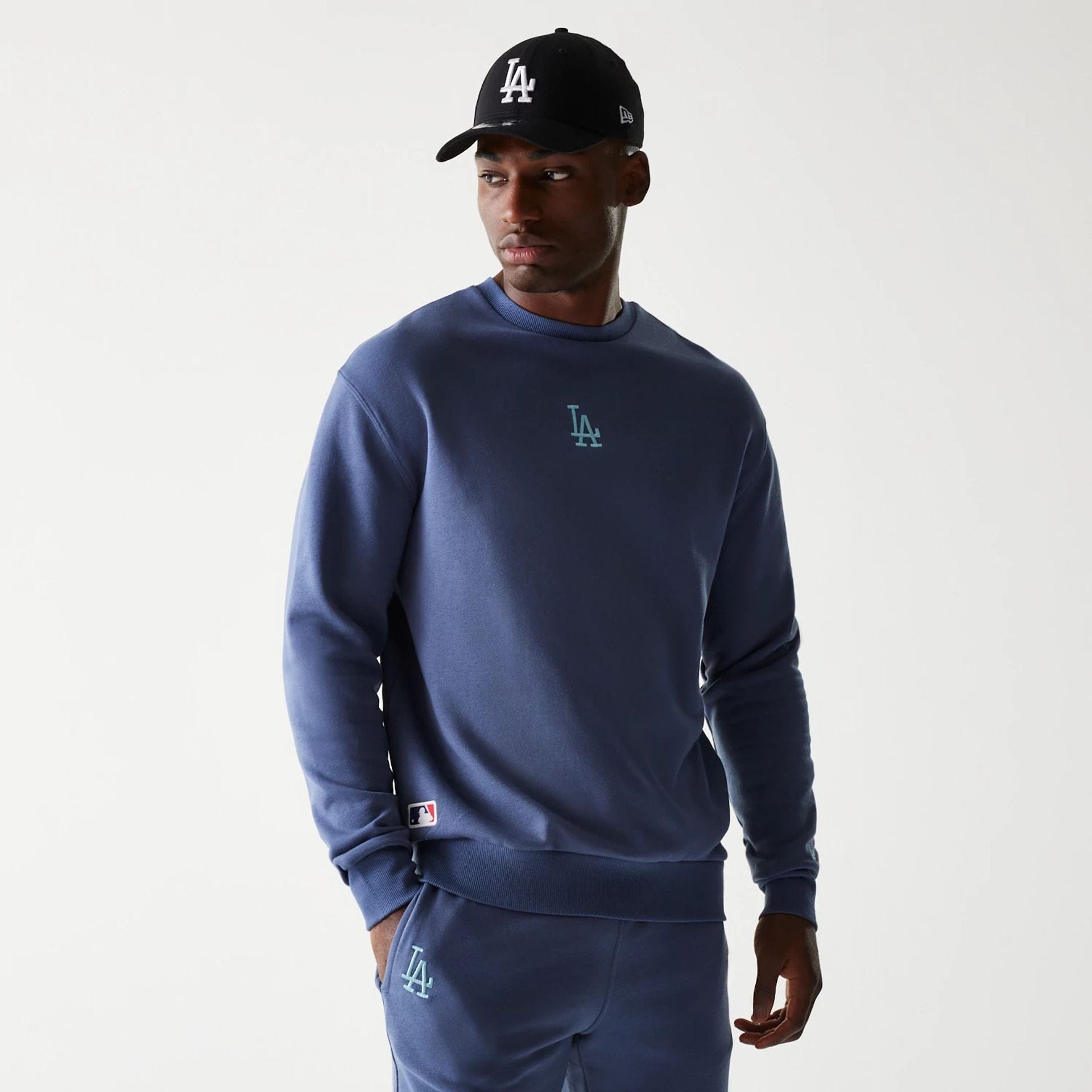 The Male model is wearing LA Dodgers MLB Midi League Essential Dark Blue Oversized Crew Neck Sweater 1