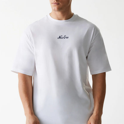 New Era Trucker Patch White Oversized T-Shirt, front view showing the plain white fabric with a black embroidered New Era logo centred on the chest, short sleeves and a relaxed oversized fit.