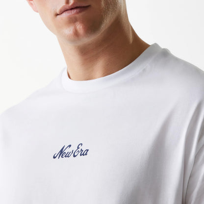 New Era Trucker Patch White Oversized T-Shirt, front view featuring a simple white design with a raised New Era logo in navy blue centred on the chest, rounded neckline and short sleeves visible on the white fabric.