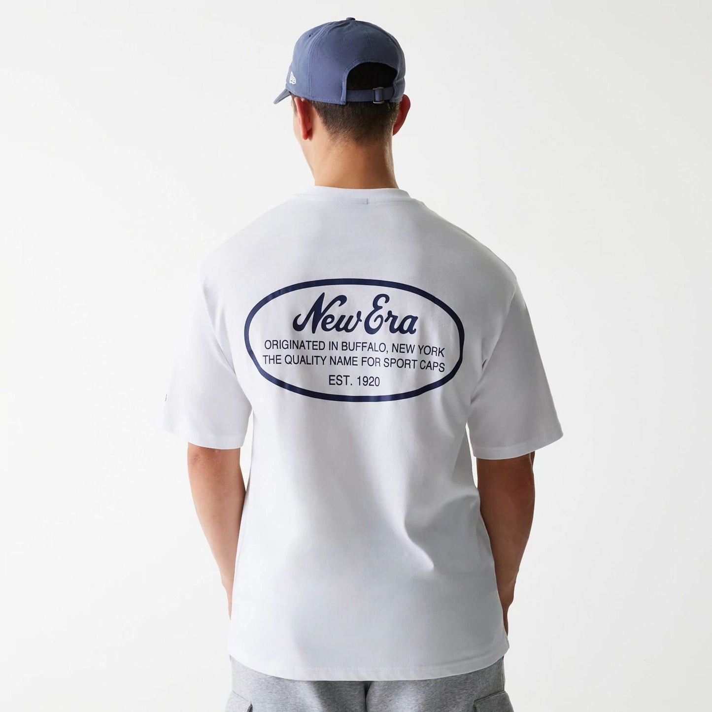 The Male model is wearing New Era Trucker Patch White Oversized T-Shirt 2