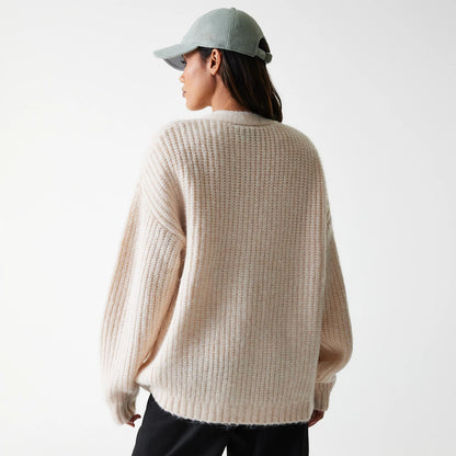 New Era LA Dodgers Womens MLB Knit Light Beige Cardigan, rear view on a model wearing a pale cap, showing full-length ribbed knit design with a relaxed fit, dropped shoulders, and ribbed cuffs for a cosy and casual look.