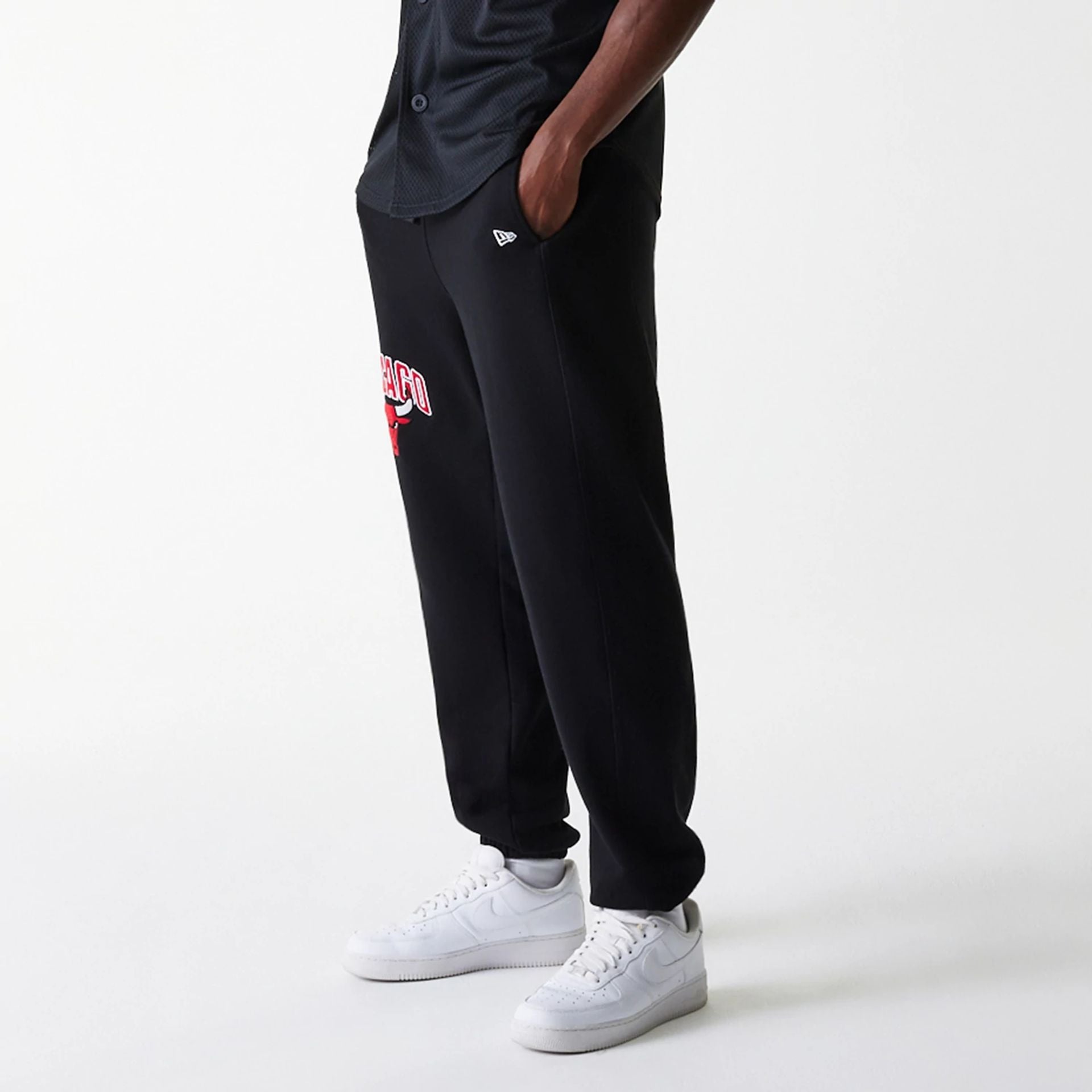 The Male model is wearing Chicago Bulls NBA Arch Graphic Black Joggers 3