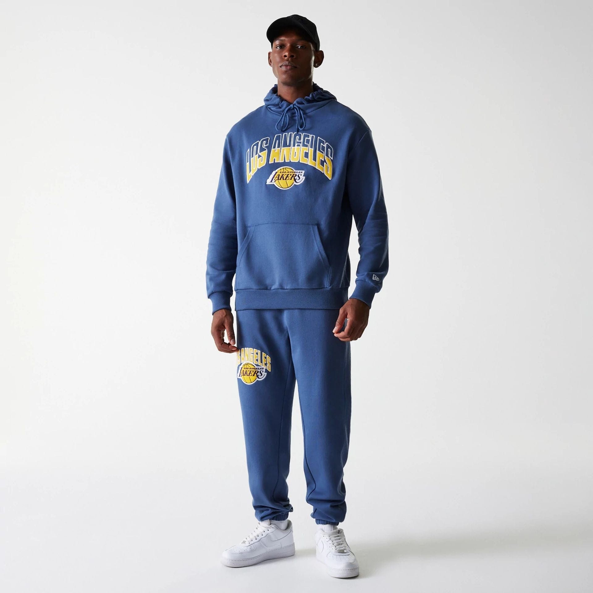 The Male model is wearing LA Lakers NBA Arch Graphic Dark Blue Joggers 3