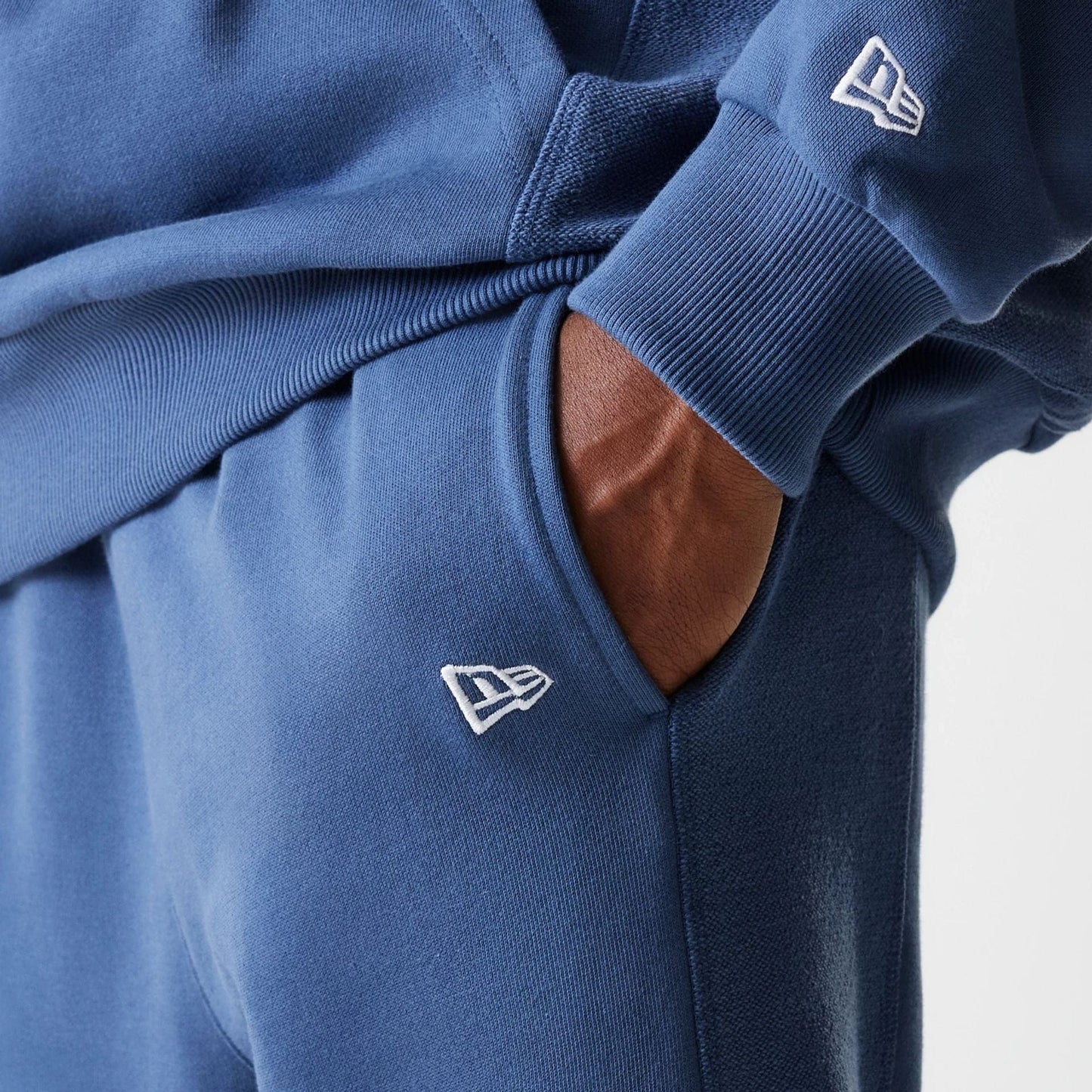 The Male model is wearing LA Lakers NBA Arch Graphic Dark Blue Joggers 7