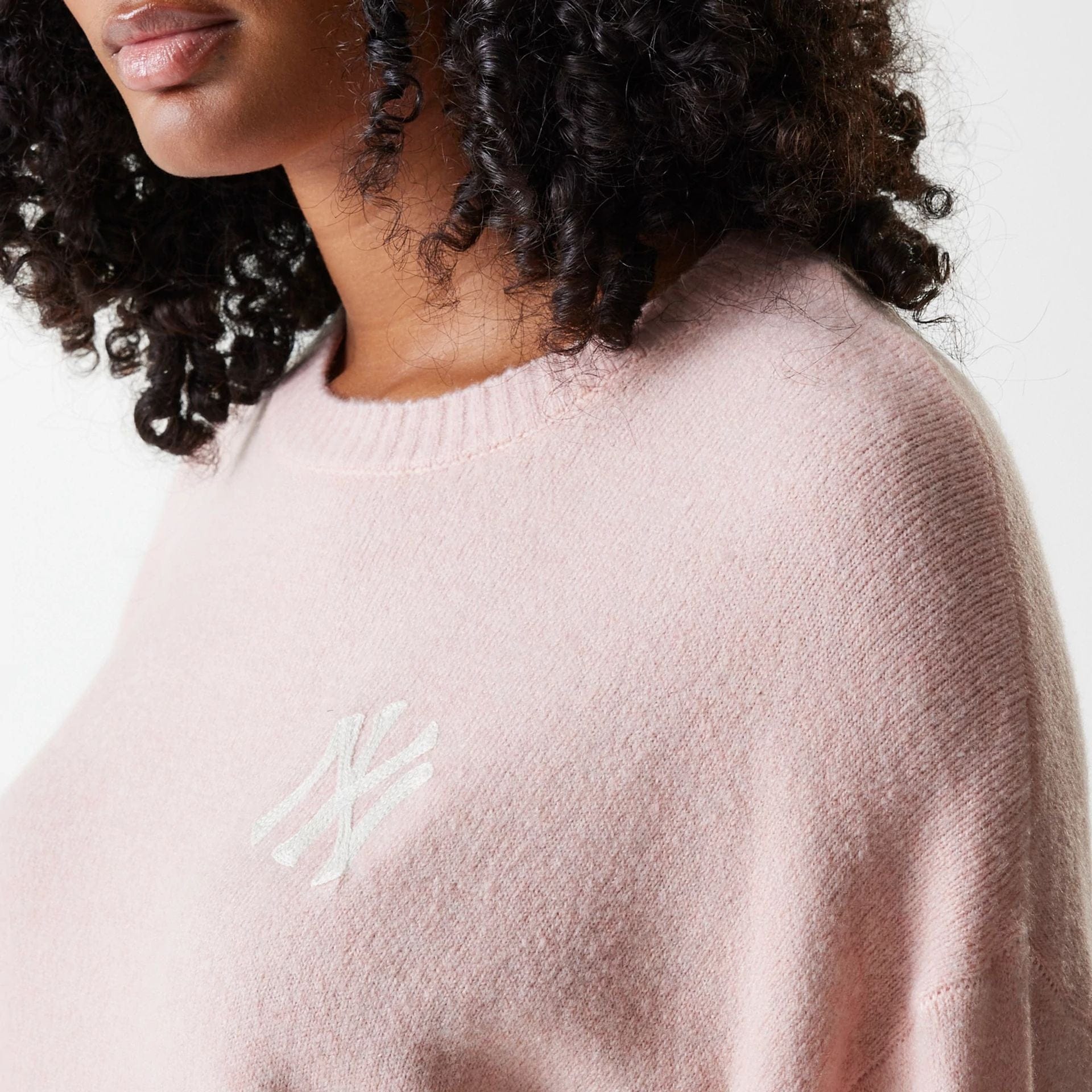 The Female model is wearing New York Yankees Womens MLB Knit Pastel Pink Crew Neck Sweater 5