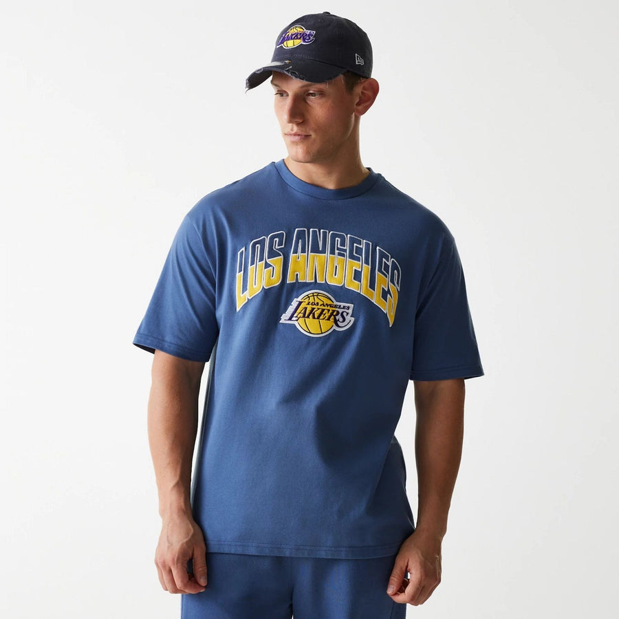 The Male model is wearing LA Lakers NBA Arch Graphic Dark Blue Oversized T-Shirt 3