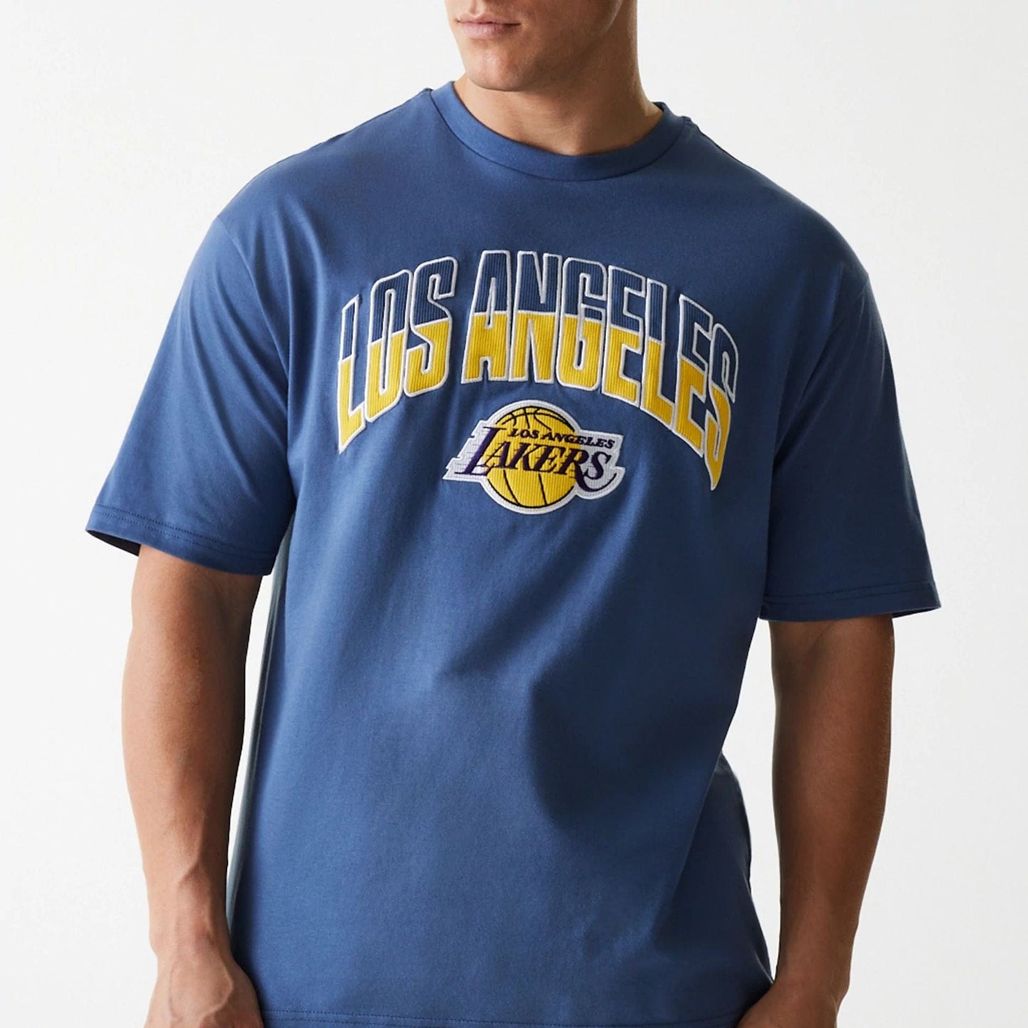 The Male model is wearing LA Lakers NBA Arch Graphic Dark Blue Oversized T-Shirt 5