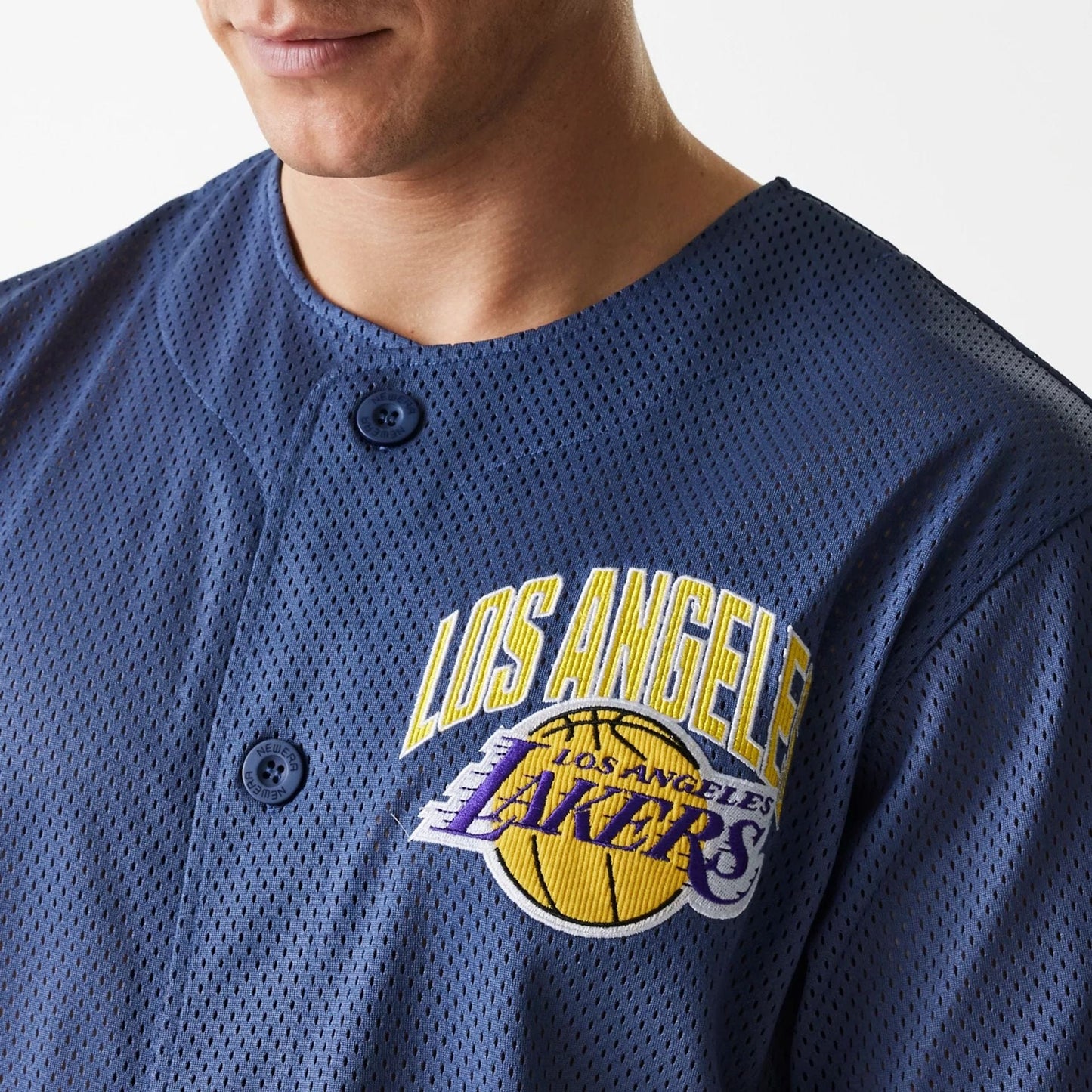The Male model is wearing LA Lakers NBA Arch Graphic Dark Blue Mesh Jersey 3