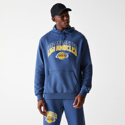 The Male model is wearing LA Lakers NBA Arch Graphic Dark Blue Oversized Pullover Hoodie 3