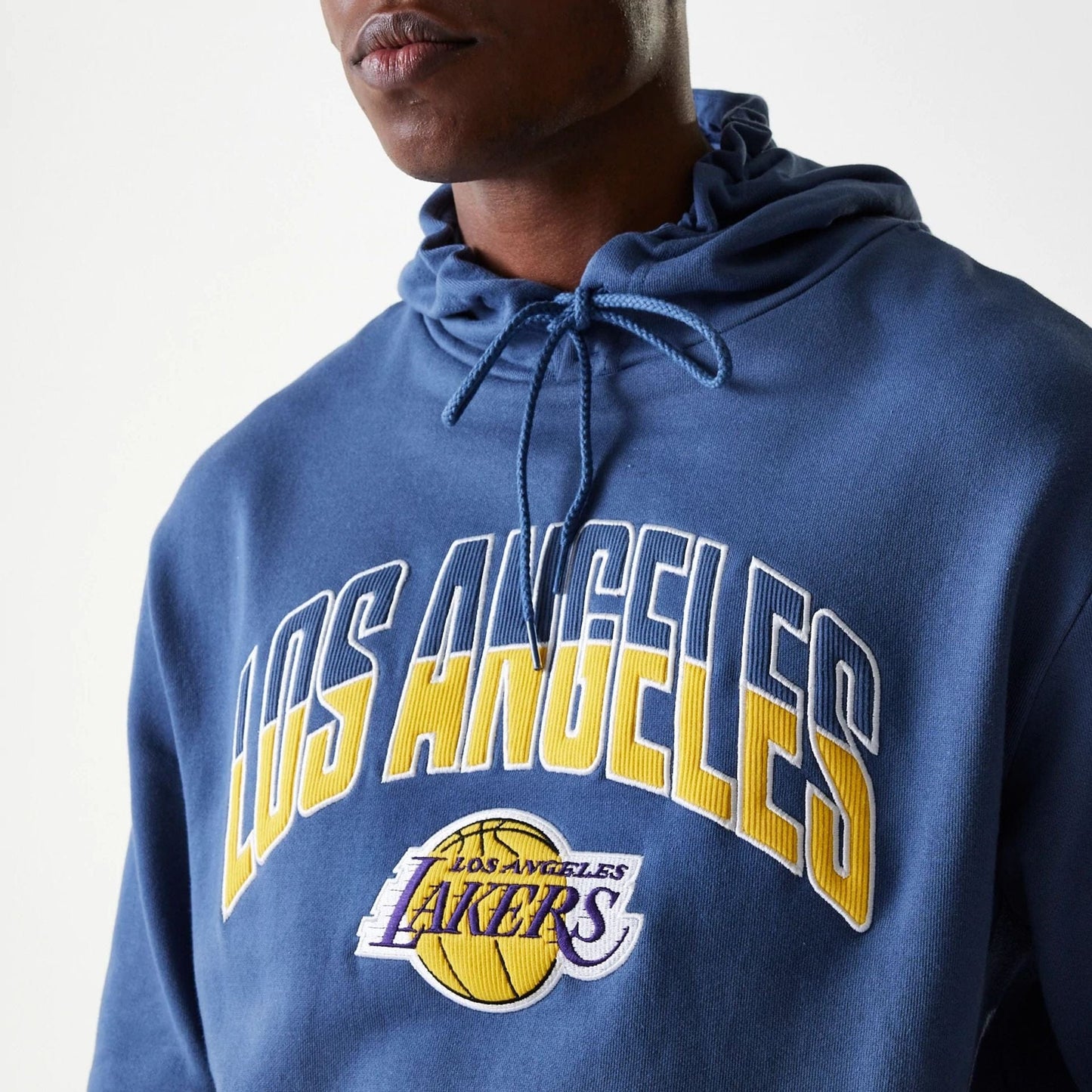The Male model is wearing LA Lakers NBA Arch Graphic Dark Blue Oversized Pullover Hoodie 6
