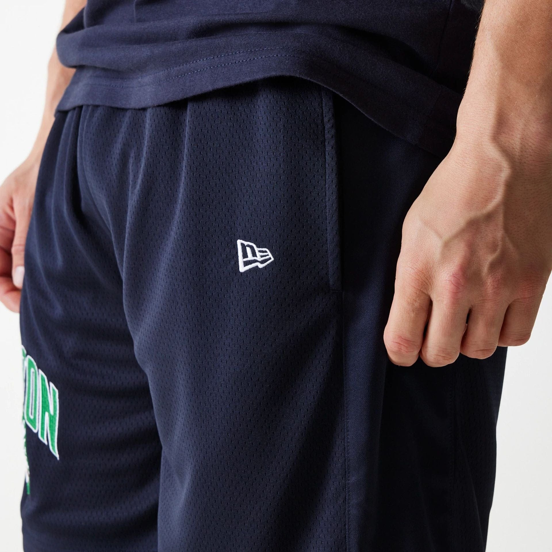The Male model is wearing Boston Celtics NBA Arch Graphic Navy Mesh Shorts 4