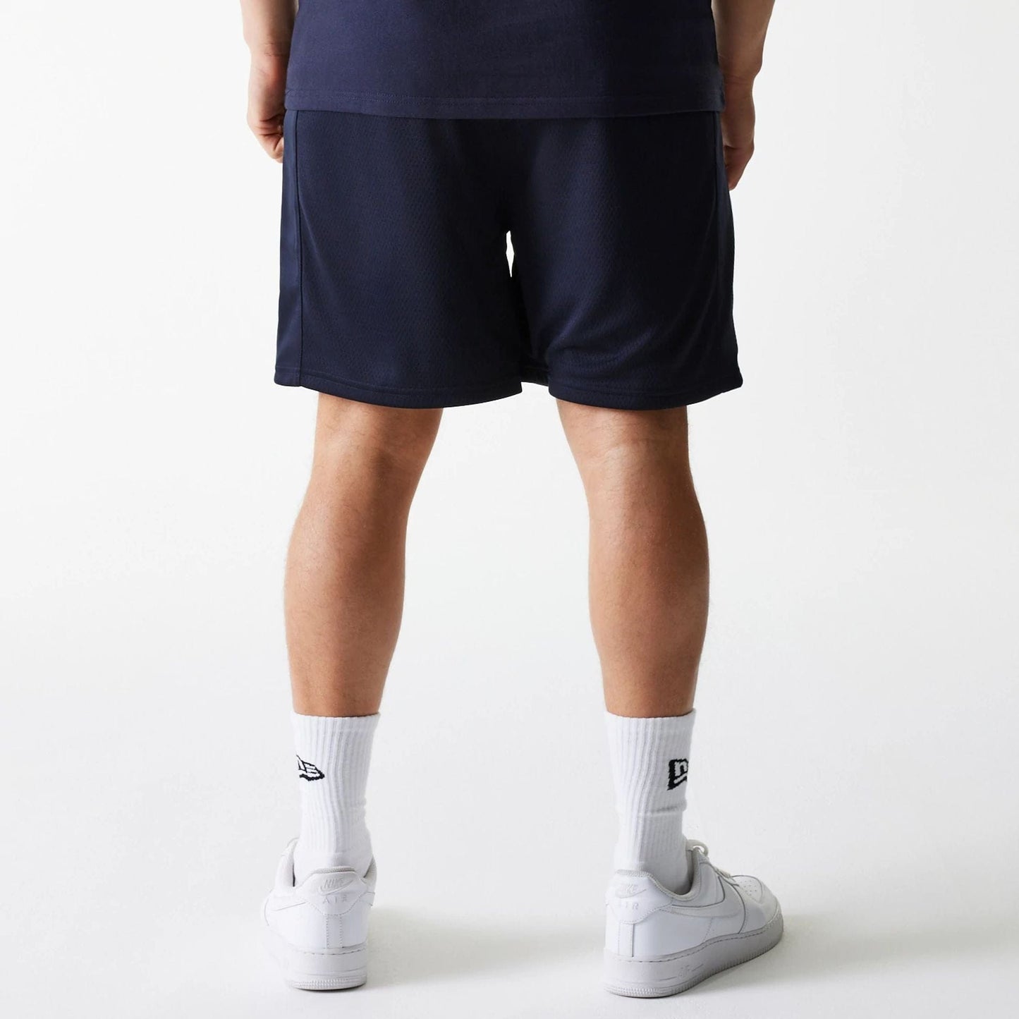 The Male model is wearing Boston Celtics NBA Arch Graphic Navy Mesh Shorts 2