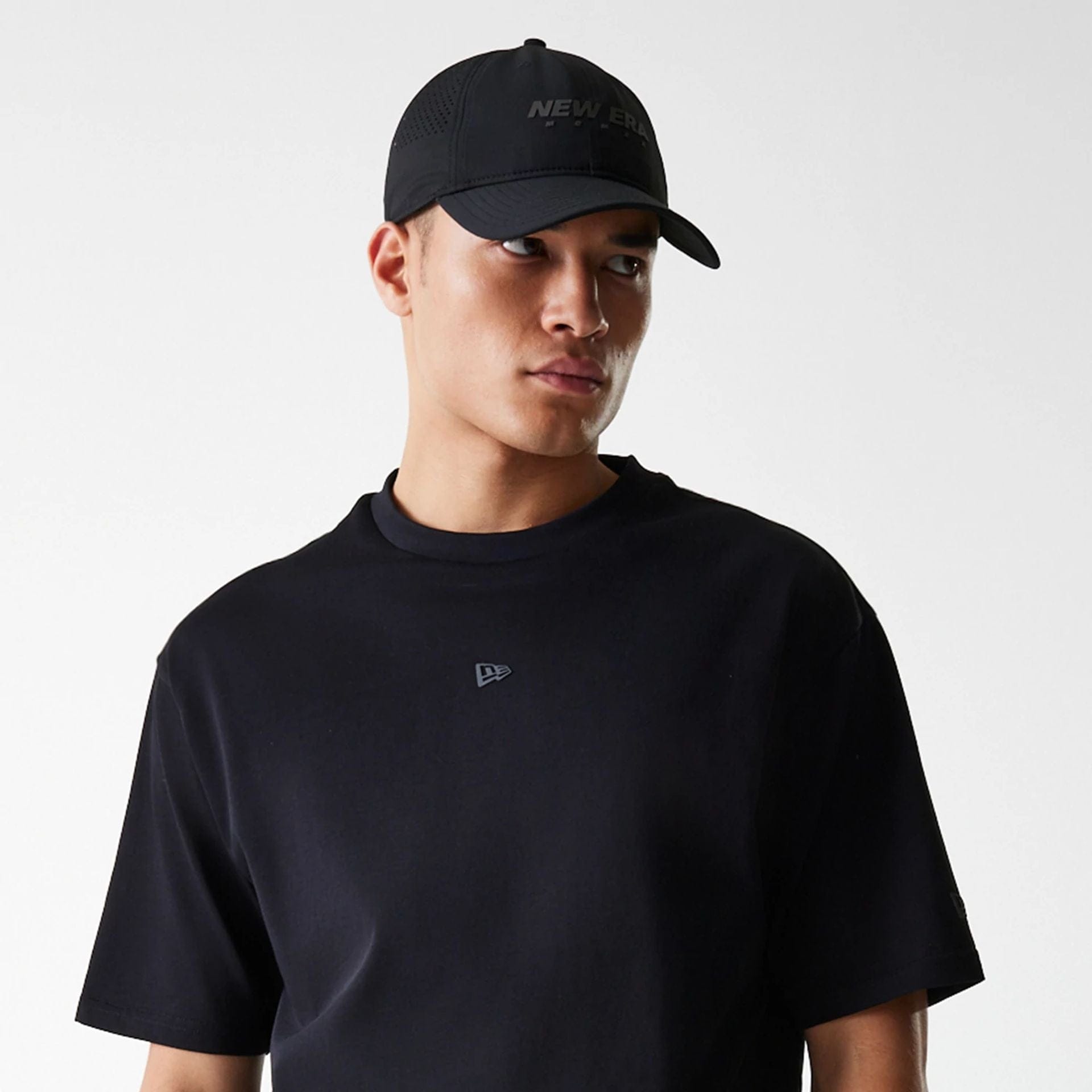 The Male model is wearing New Era Tech Black Oversized T-Shirt 5