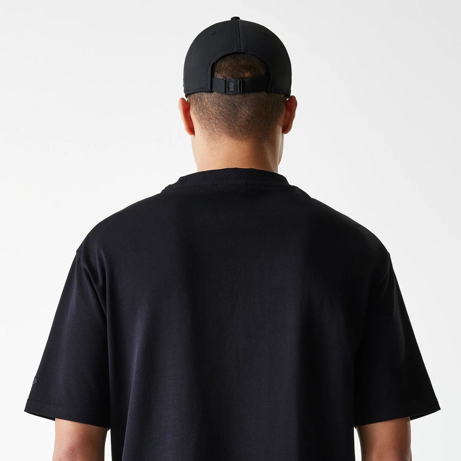 The Male model is wearing New Era Tech Black Oversized T-Shirt 6