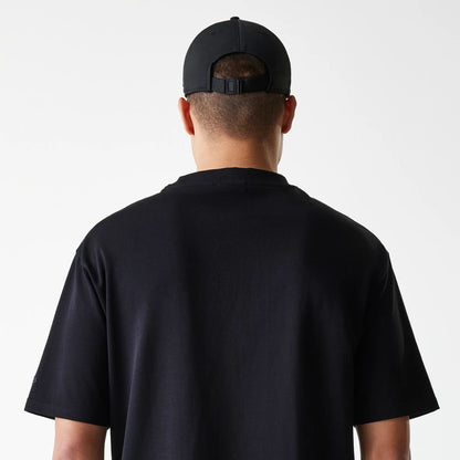The Male model is wearing New Era Tech Black Oversized T-Shirt 6