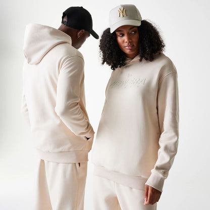 The Male model is wearing New Era Tech Light Beige Oversized Pullover Hoodie 1