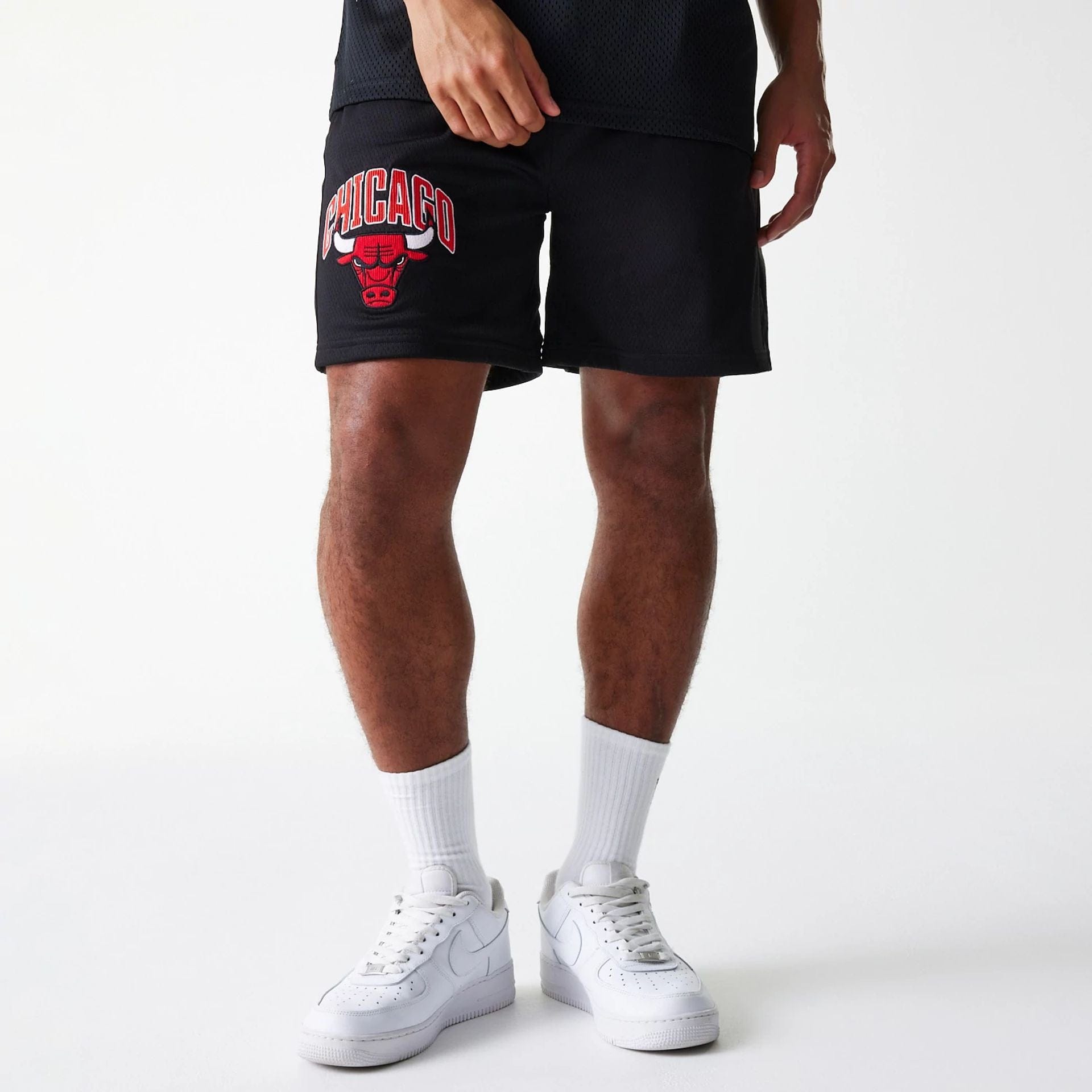 The Male model is wearing Chicago Bulls NBA Arch Graphic Black Mesh Shorts 1