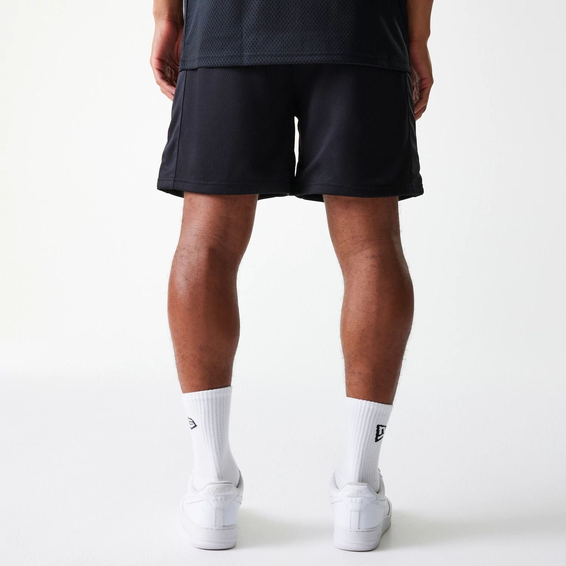 The Male model is wearing Chicago Bulls NBA Arch Graphic Black Mesh Shorts 2