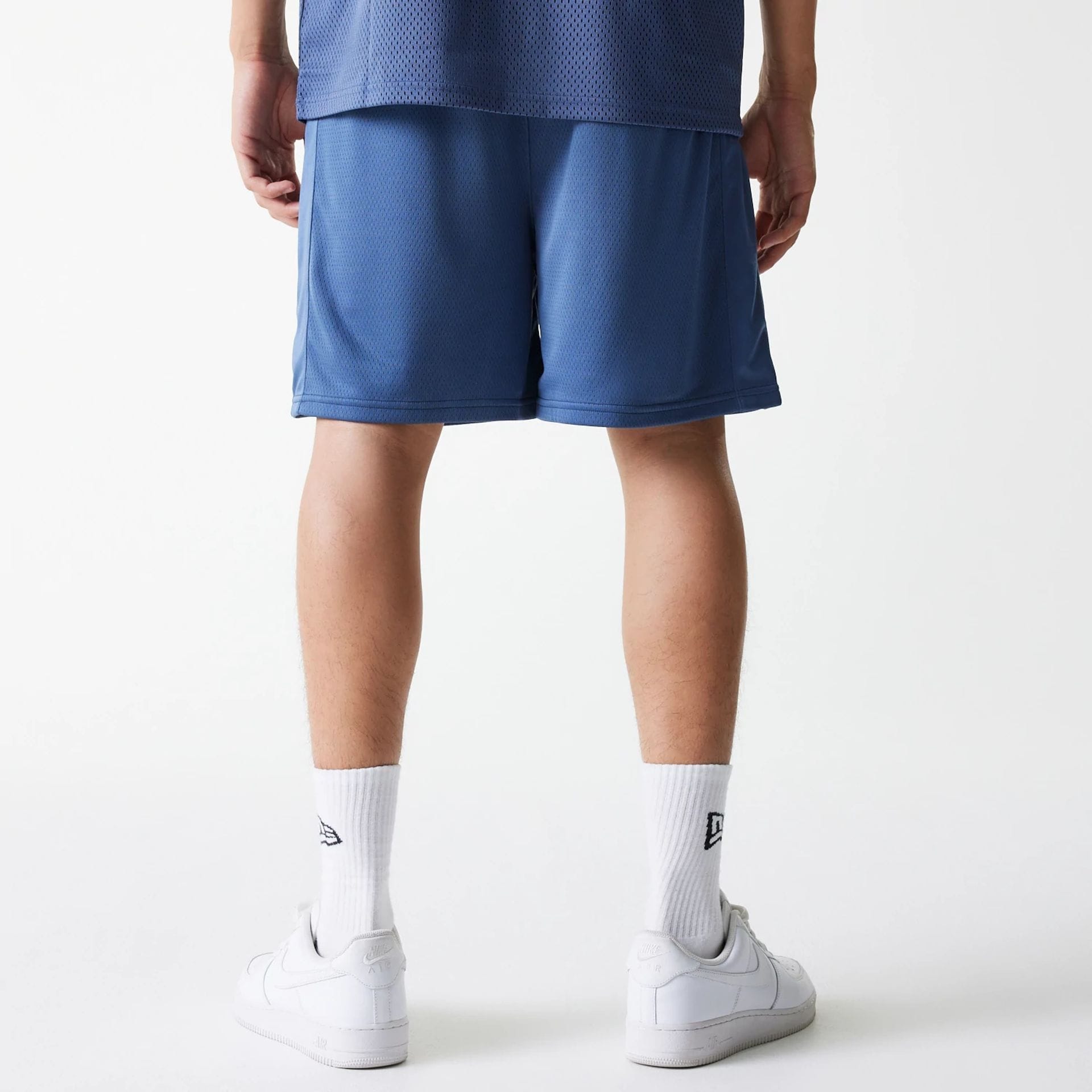 The Male model is wearing LA Lakers NBA Arch Graphic Dark Blue Mesh Shorts 2