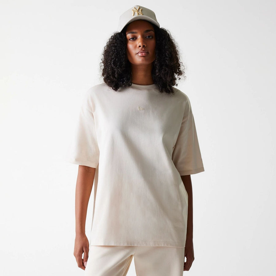 The Male model is wearing New Era Tech Light Beige Oversized T-Shirt 4