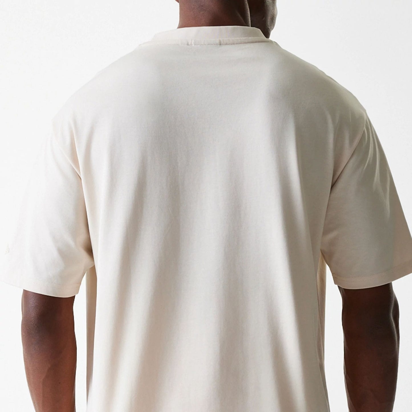 The Male model is wearing New Era Tech Light Beige Oversized T-Shirt 8