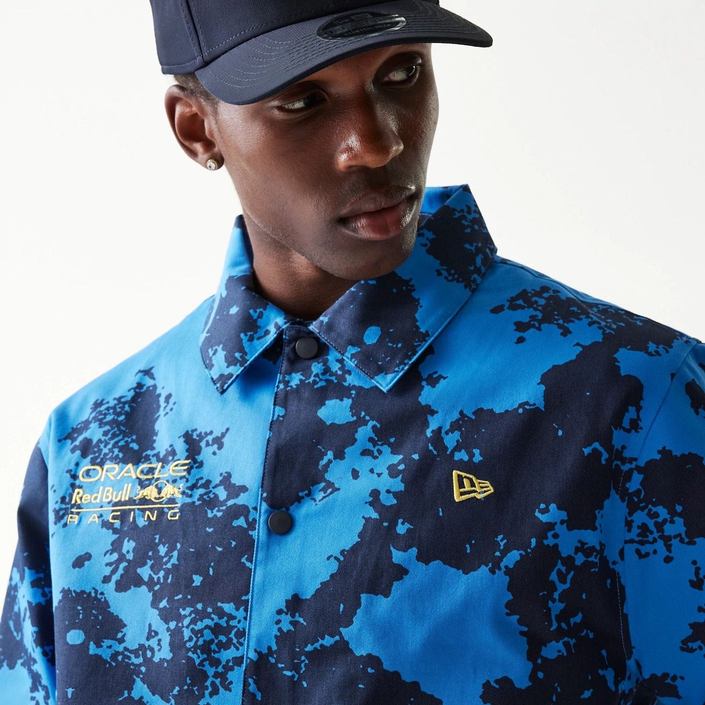 The Male model is wearing Red Bull Racing Blue Oversized Coaches Jacket 3