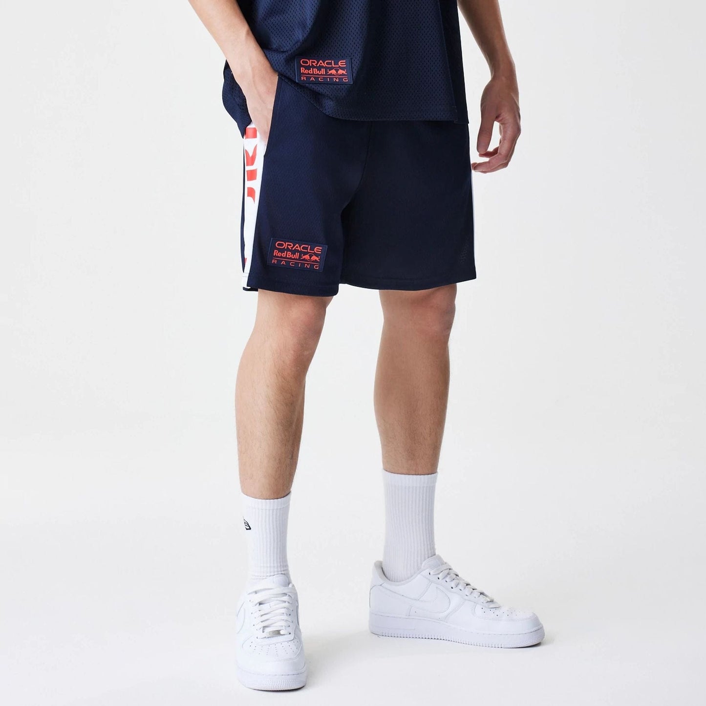 The Male model is wearing Red Bull Racing Graphic Mesh Dark Blue Shorts 1