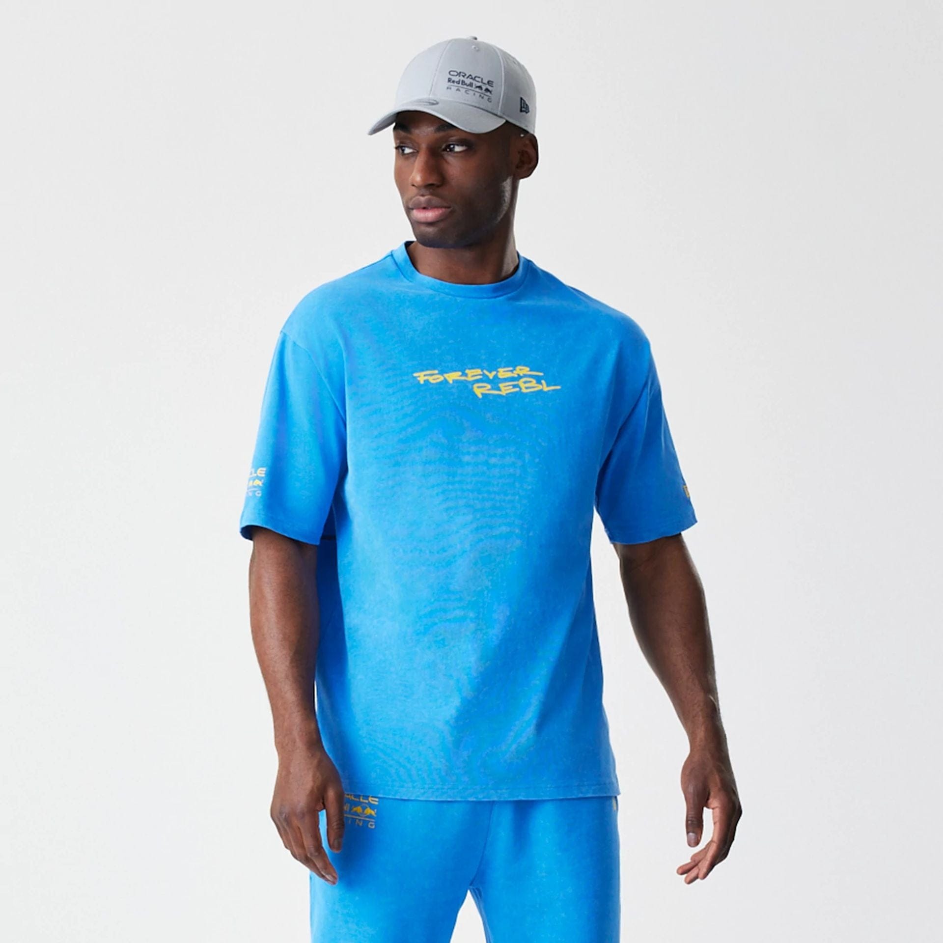 The Male model is wearing Red Bull Racing Back Graphic Blue Oversized T-Shirt 6