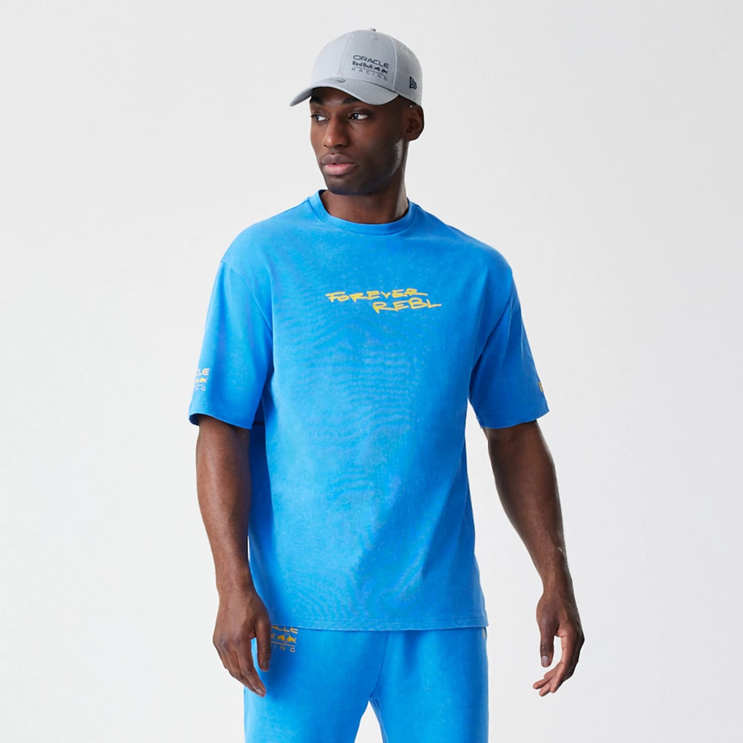 The Male model is wearing Red Bull Racing Back Graphic Blue Oversized T-Shirt 6