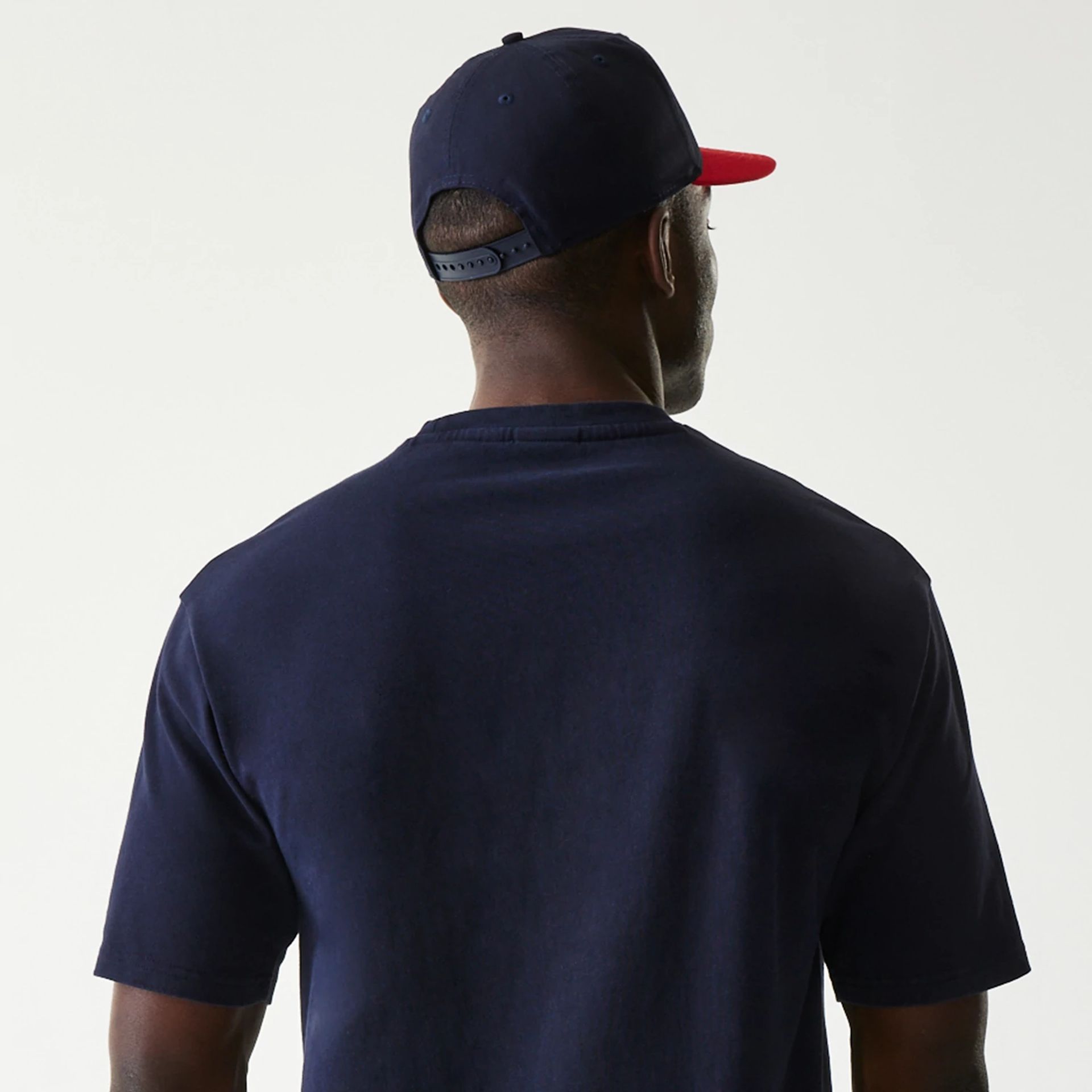The Male model is wearing Red Bull Racing Dark Blue Oversized T-Shirt 7