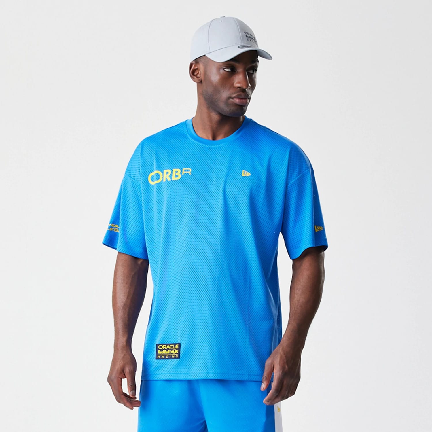 The Male model is wearing Red Bull Racing Graphic Mesh Blue Oversized T-Shirt 6