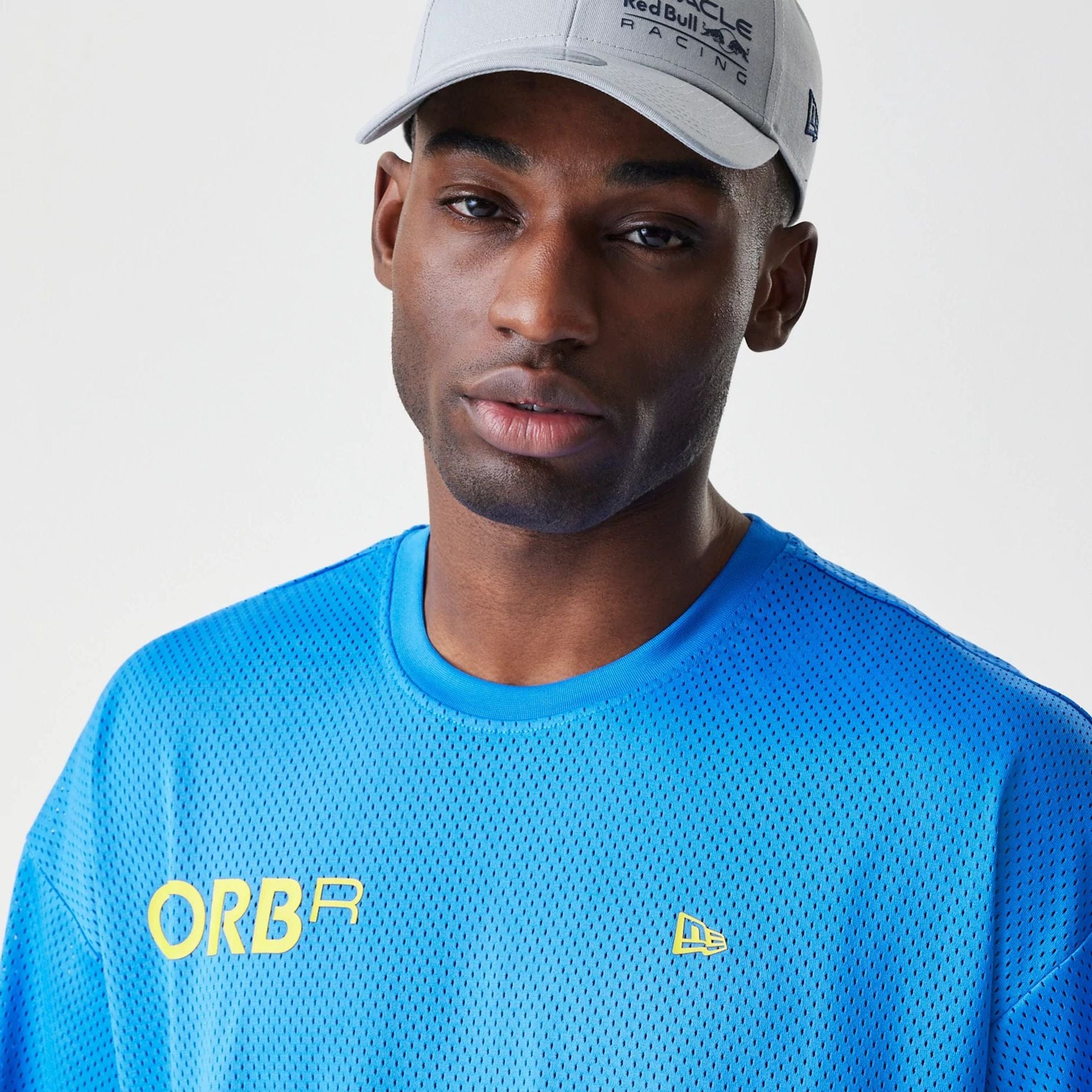 The Male model is wearing Red Bull Racing Graphic Mesh Blue Oversized T-Shirt 3