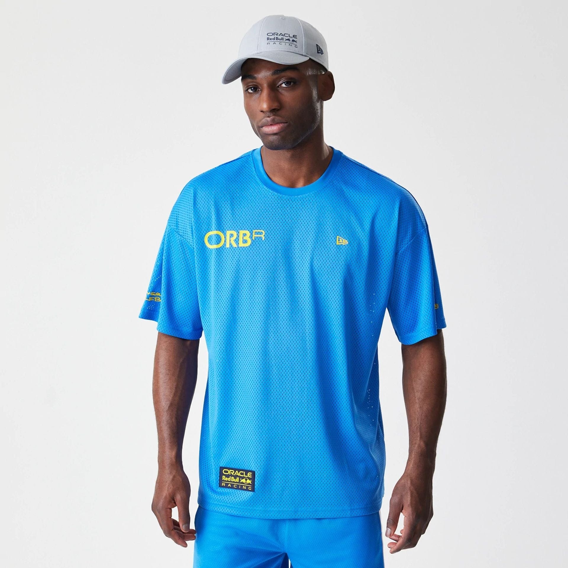 The Male model is wearing Red Bull Racing Graphic Mesh Blue Oversized T-Shirt 1