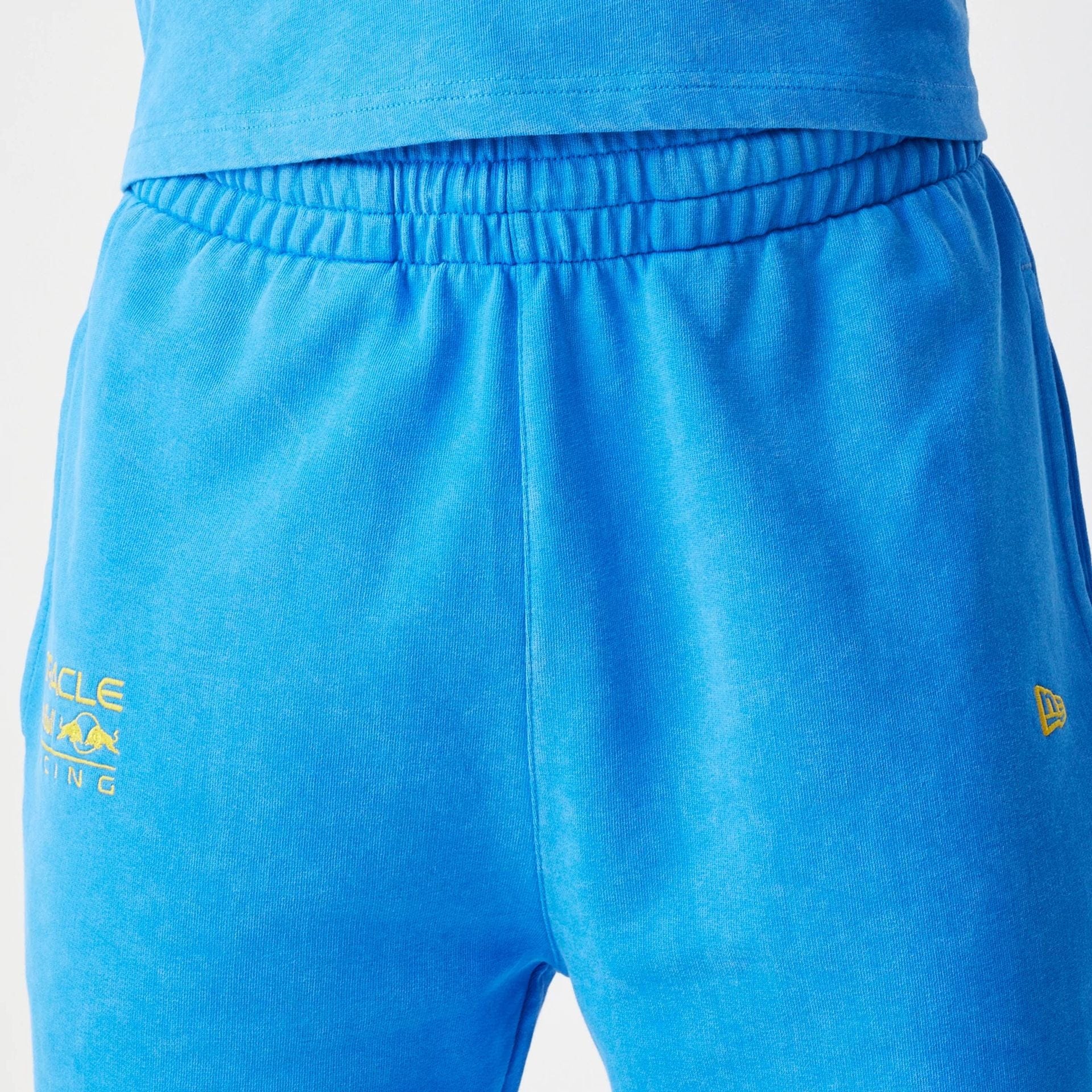 The Male model is wearing Red Bull Racing Blue Joggers 4