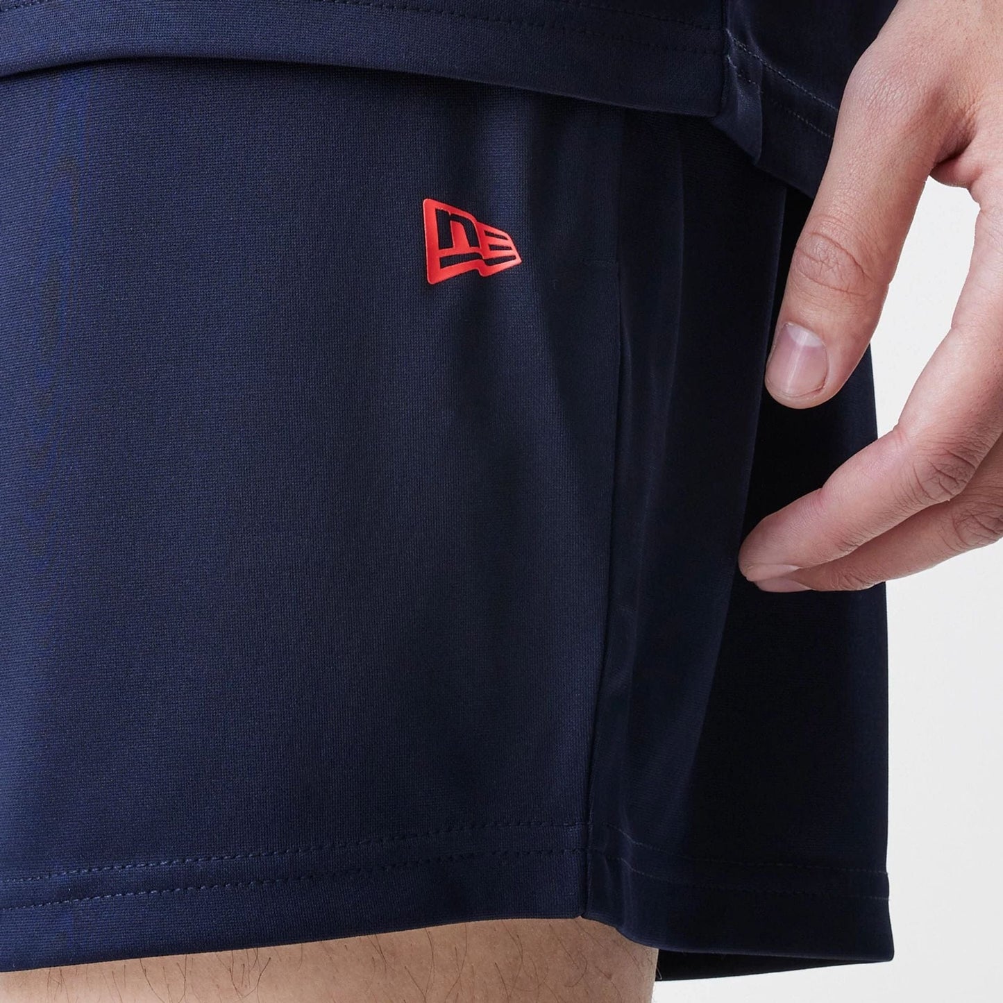 The Male model is wearing Red Bull Racing Graphic Dark Blue Football Shorts 4