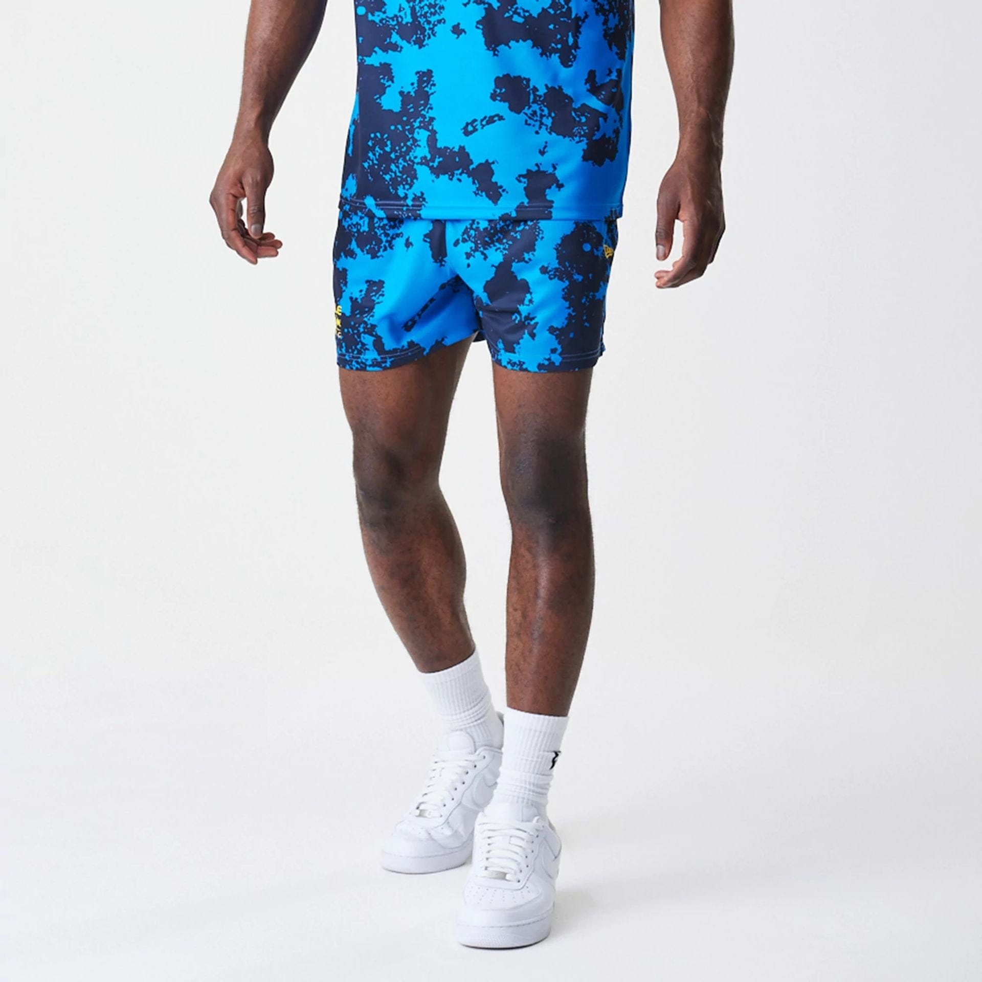 The Male model is wearing Red Bull Racing Graphic Blue Football Shorts 7
