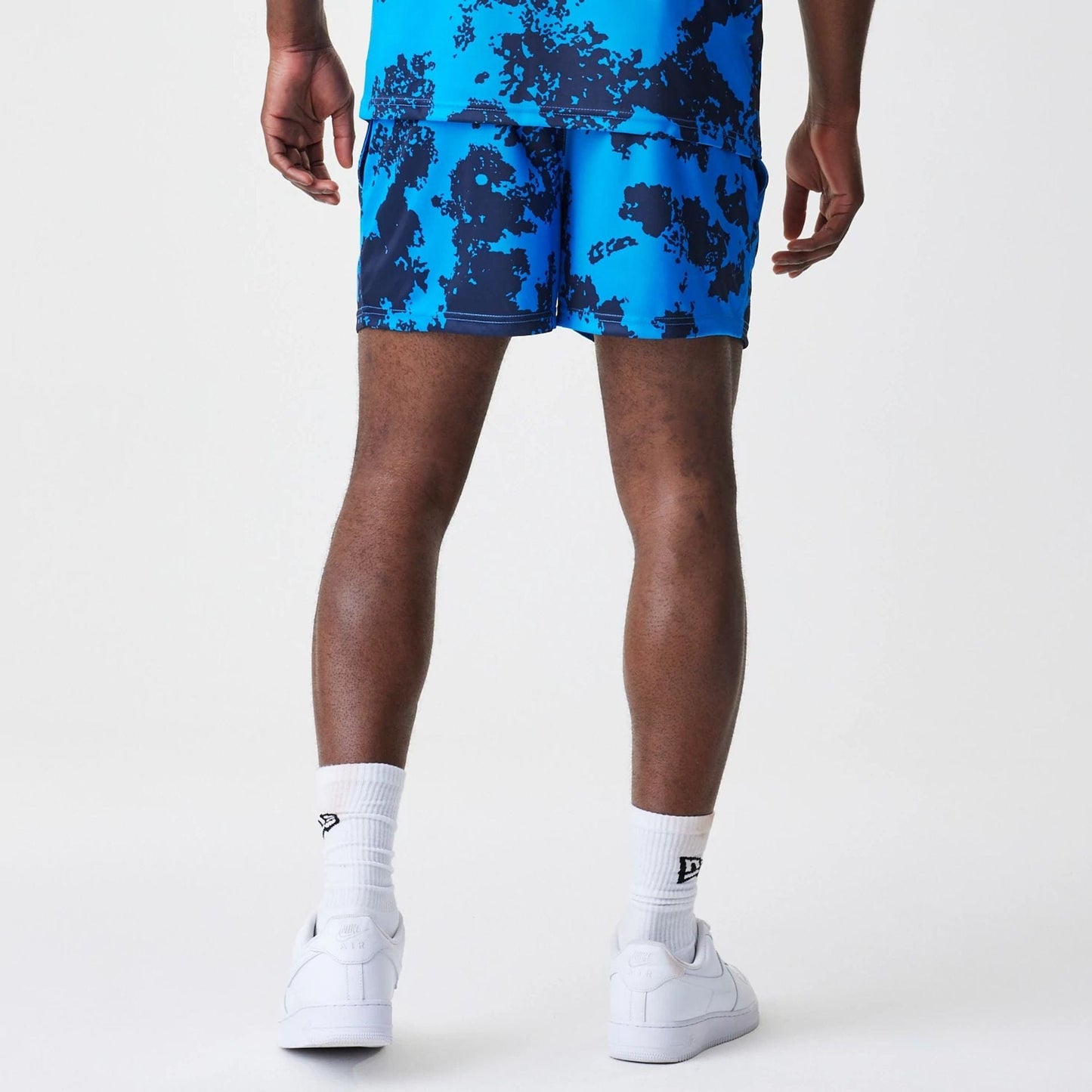 The Male model is wearing Red Bull Racing Graphic Blue Football Shorts 2