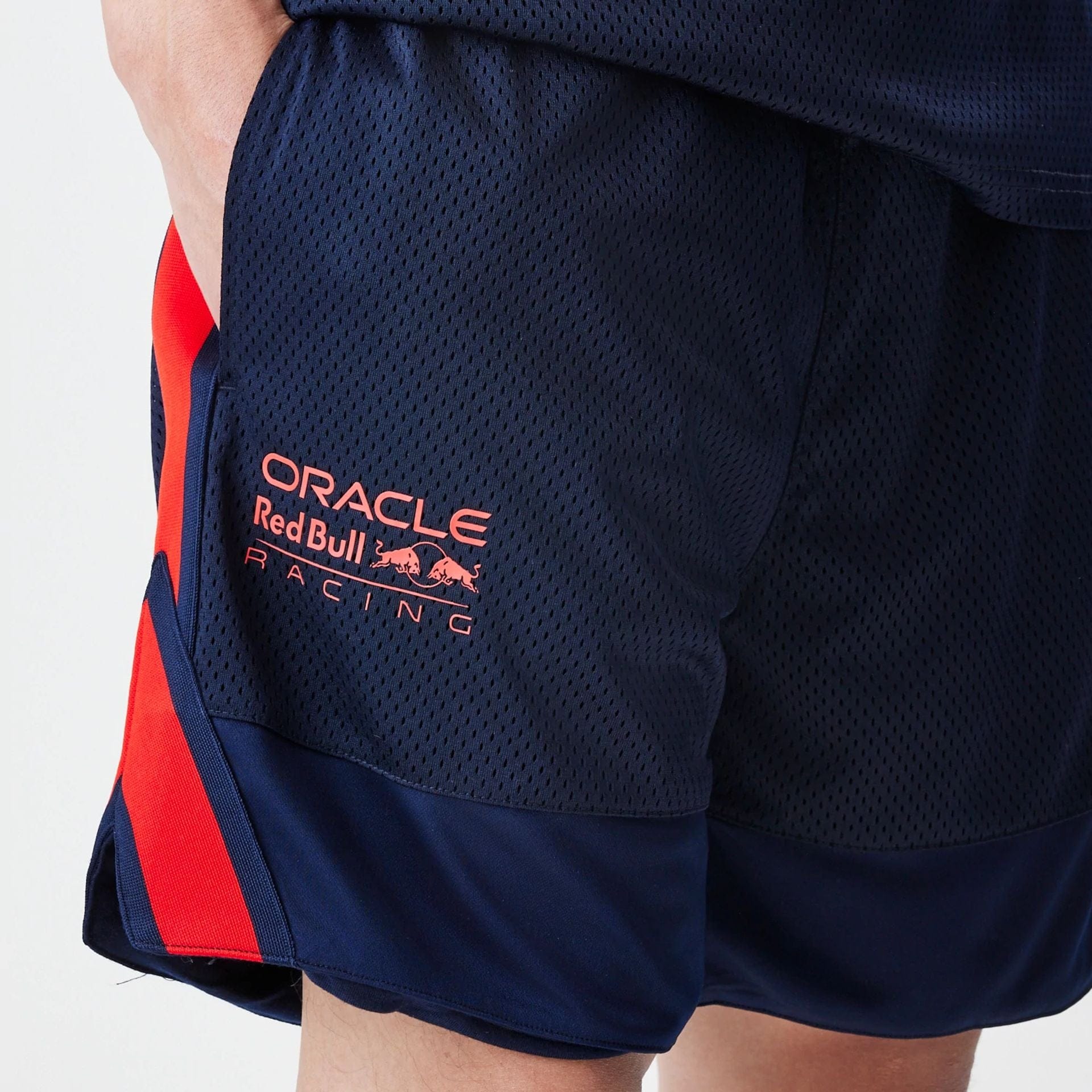 The Male model is wearing Red Bull Racing Basketball Mesh Dark Blue Shorts 3
