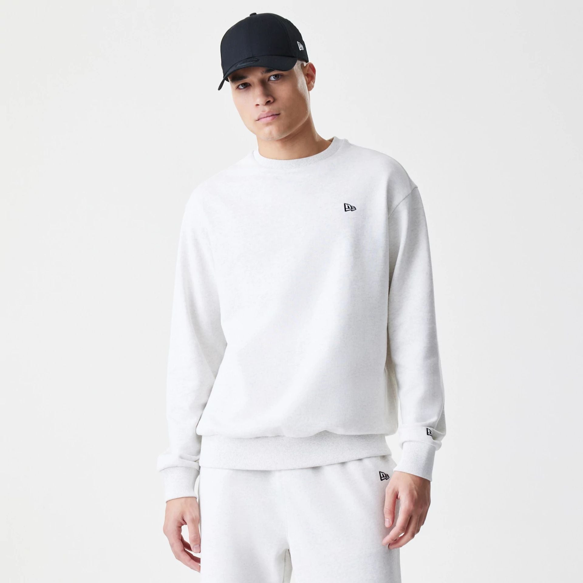 The Male model is wearing New Era Premium Essential Pastel Grey Oversized Crew Neck Sweater 1