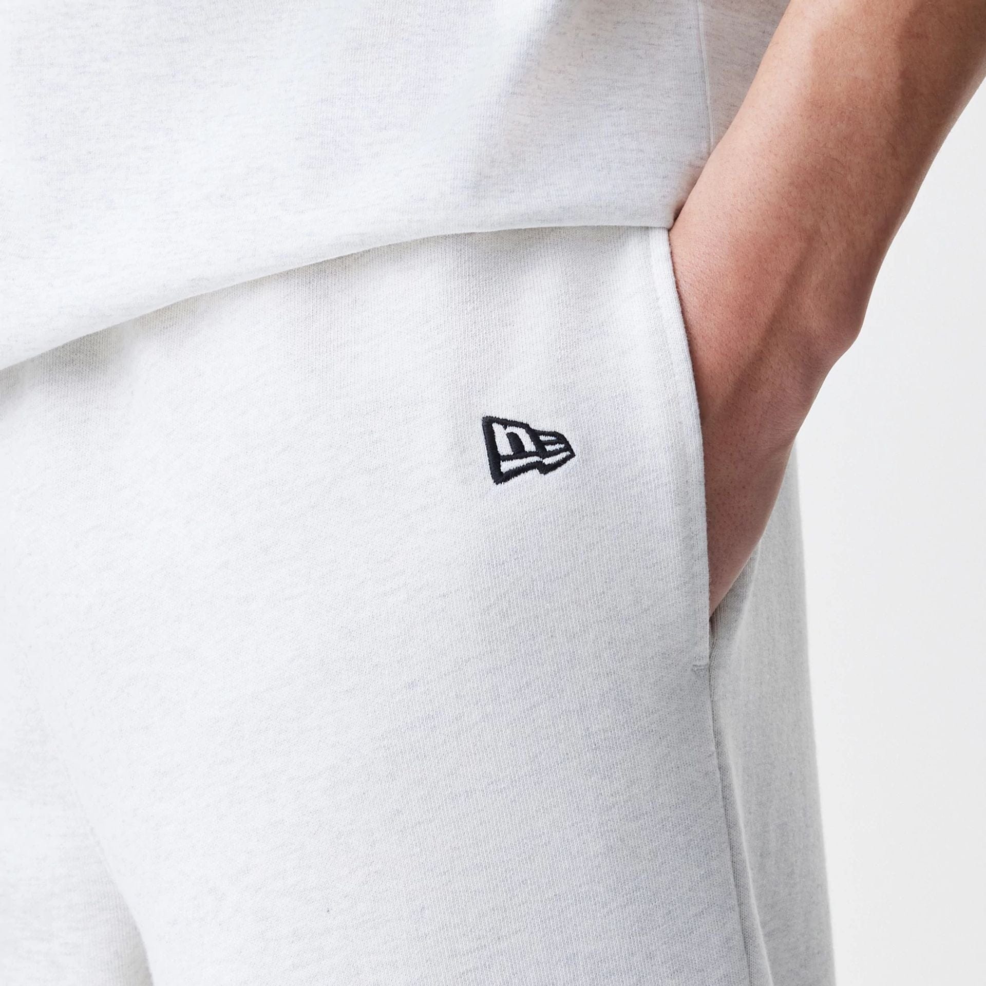 The Male model is wearing New Era Premium Essential Pastel Grey Joggers 5