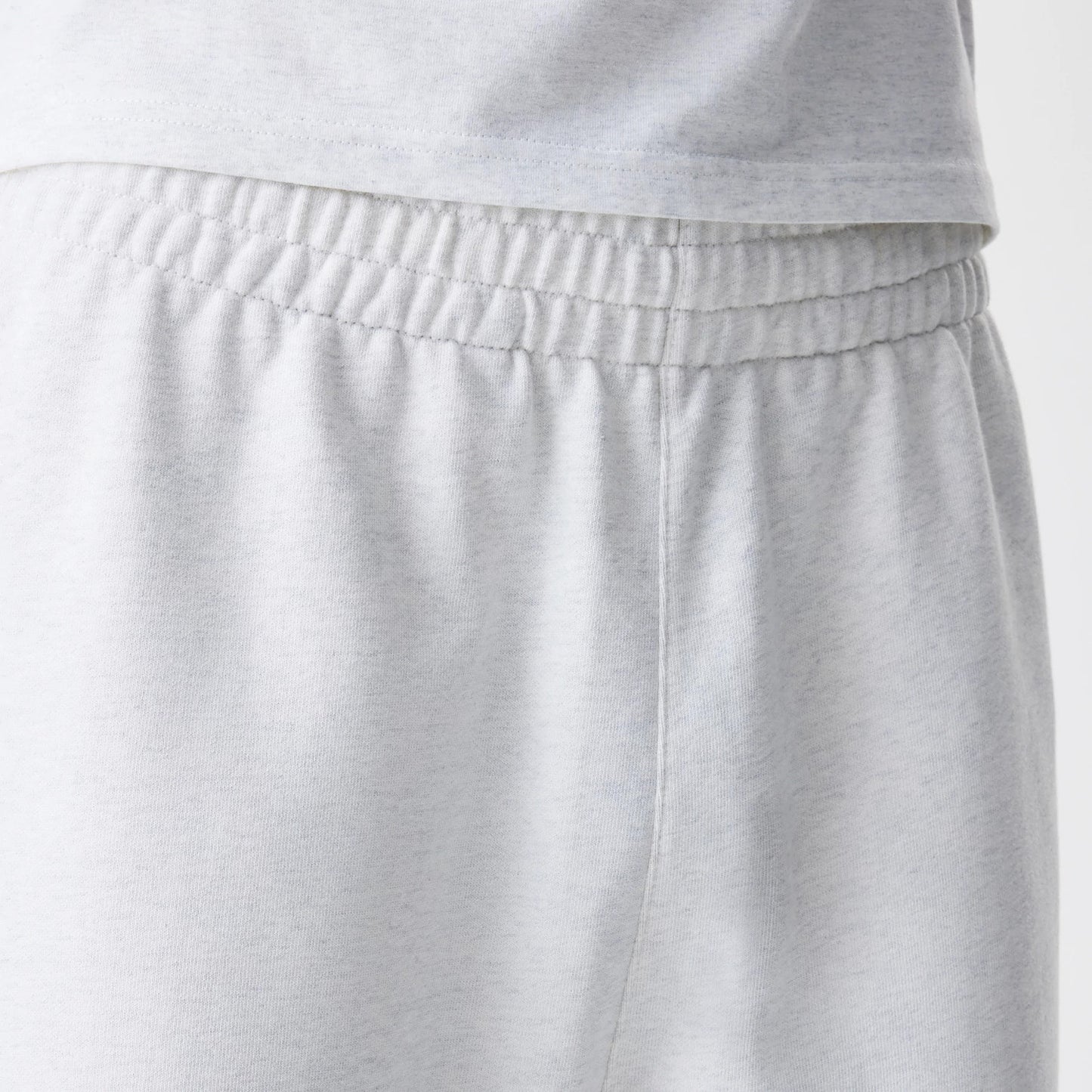The Male model is wearing New Era Premium Essential Pastel Grey Joggers 6