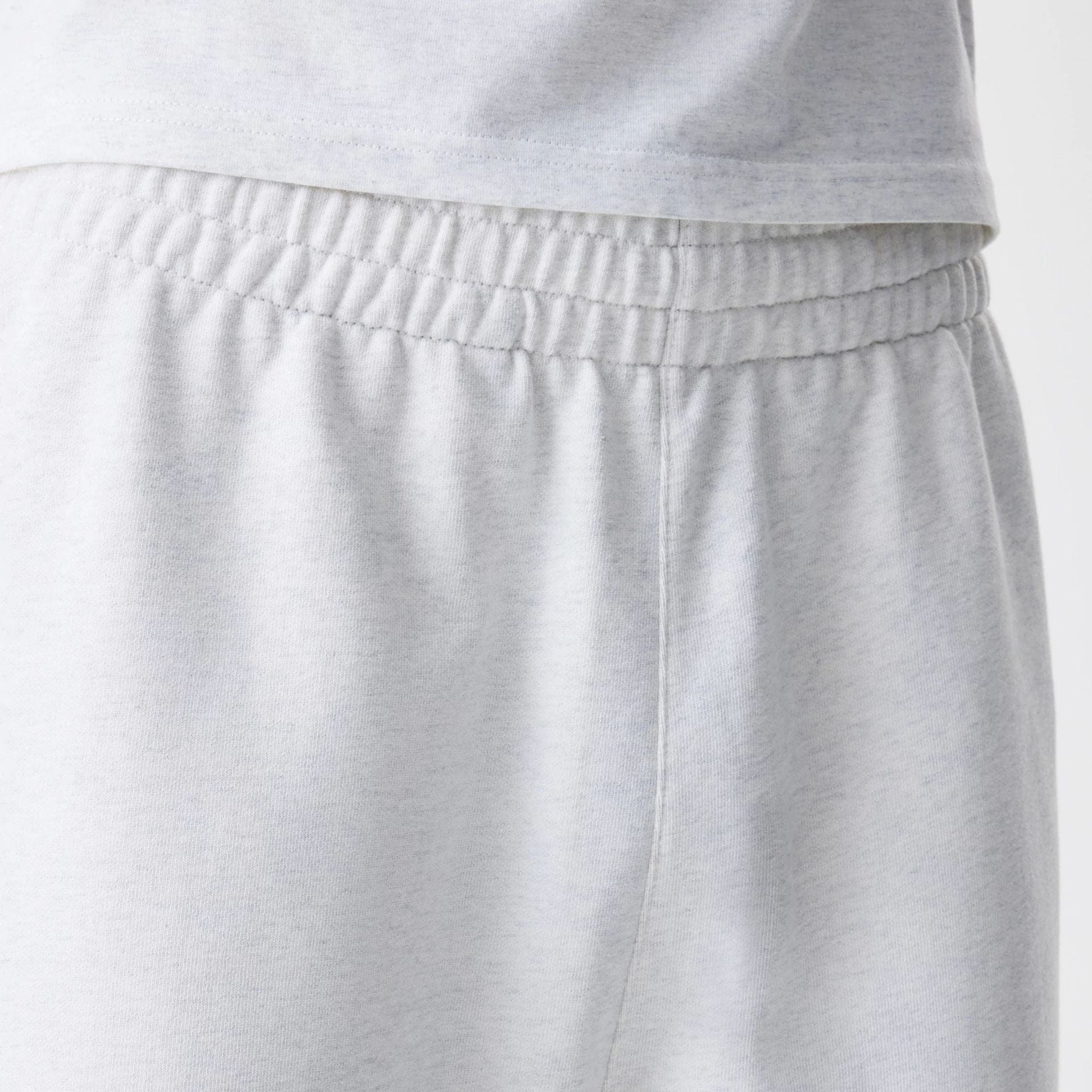 The Male model is wearing New Era Premium Essential Pastel Grey Joggers 6