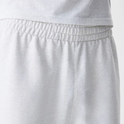 The Male model is wearing New Era Premium Essential Pastel Grey Joggers 6