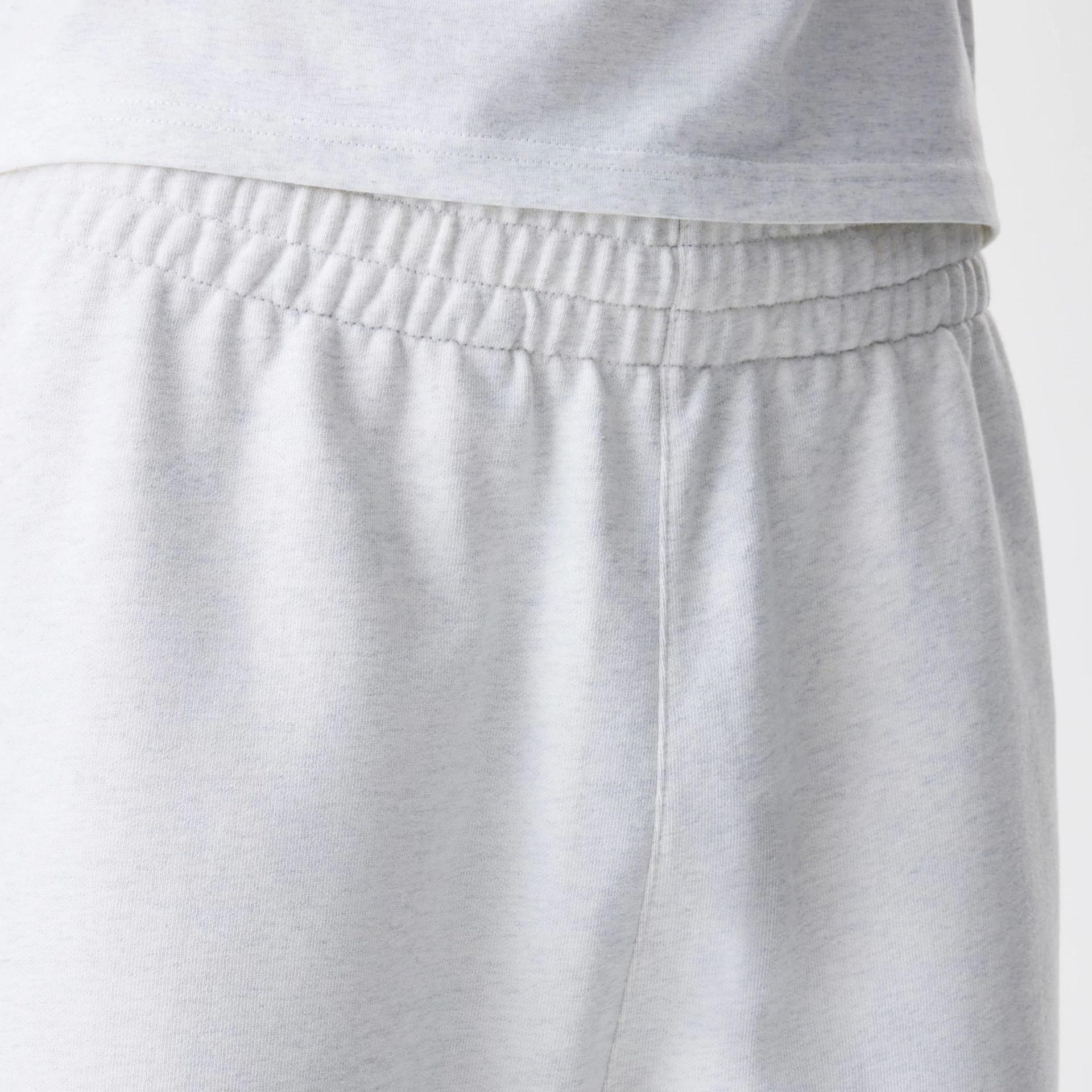 The Male model is wearing New Era Premium Essential Pastel Grey Joggers 6