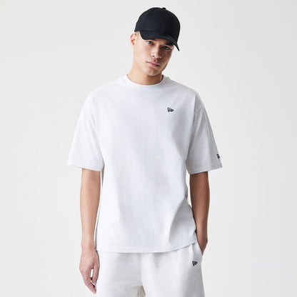 The Male model is wearing New Era Premium Essential Pastel Grey Oversized T-Shirt 1