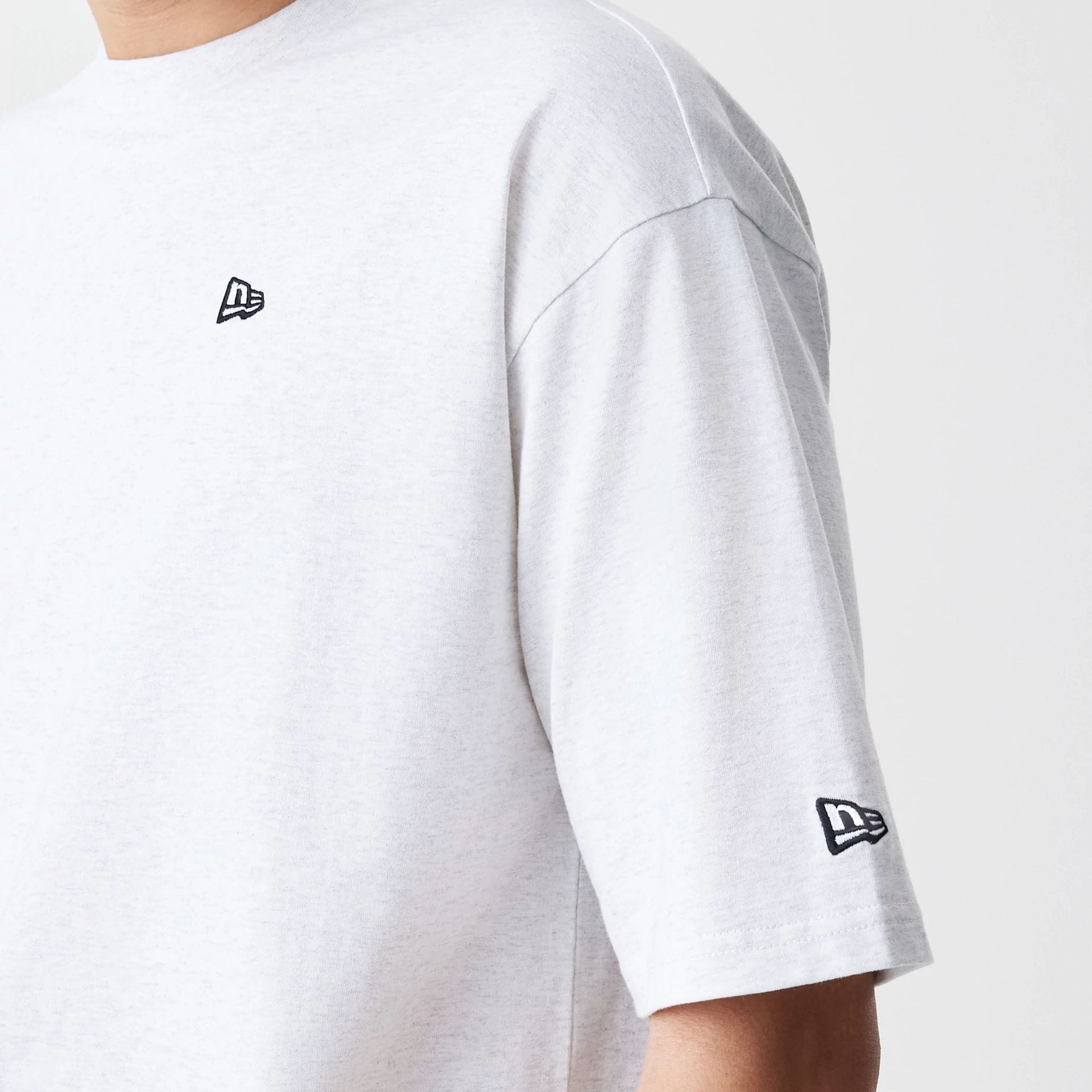 The Male model is wearing New Era Premium Essential Pastel Grey Oversized T-Shirt 5