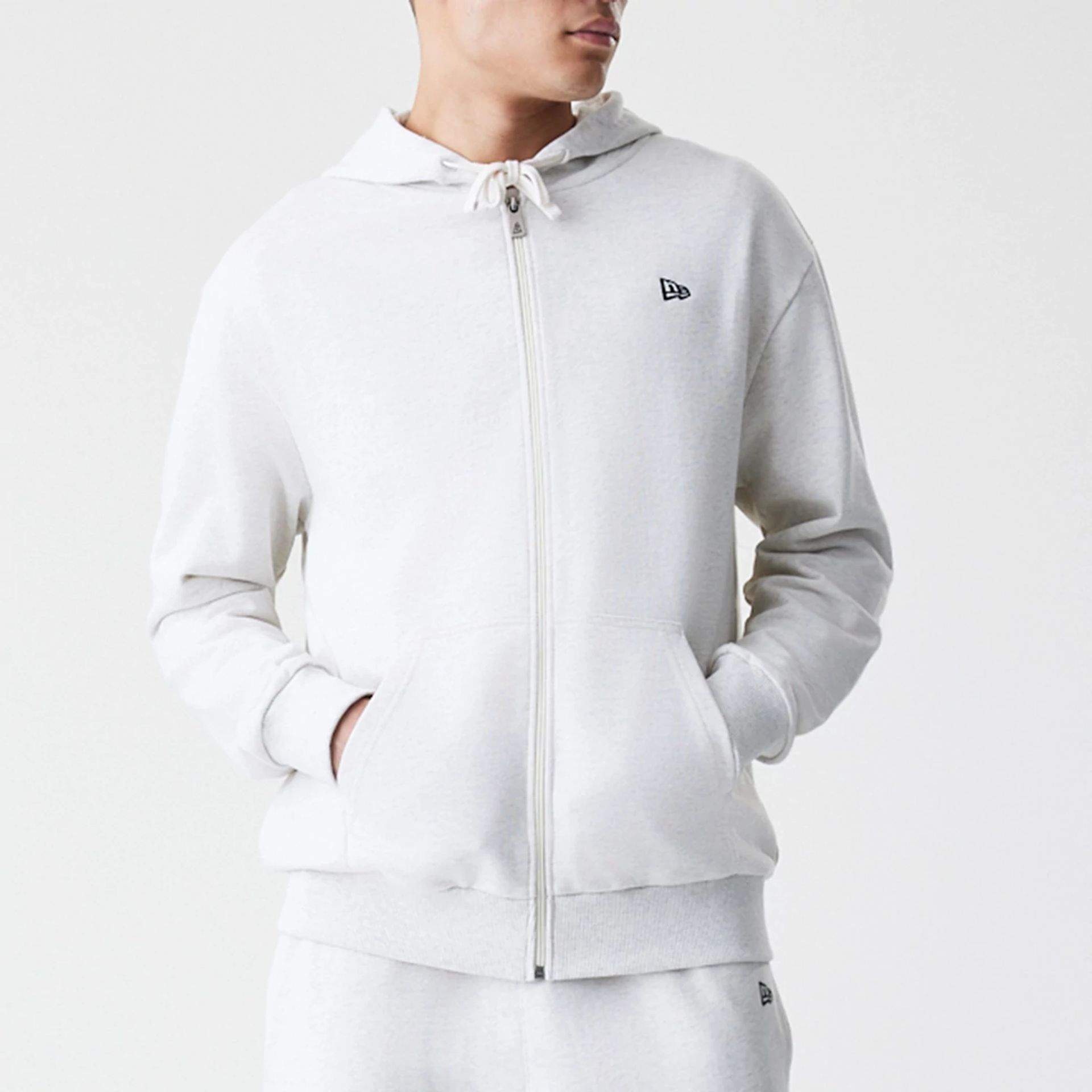 The Male model is wearing New Era Premium Essential Pastel Grey Oversized Full Zip Hoodie 3
