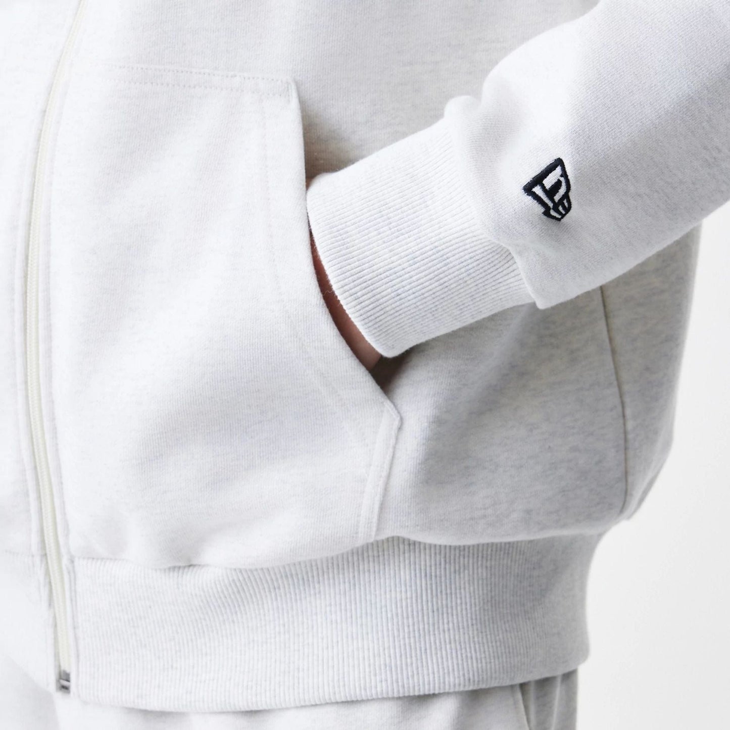 The Male model is wearing New Era Premium Essential Pastel Grey Oversized Full Zip Hoodie 5