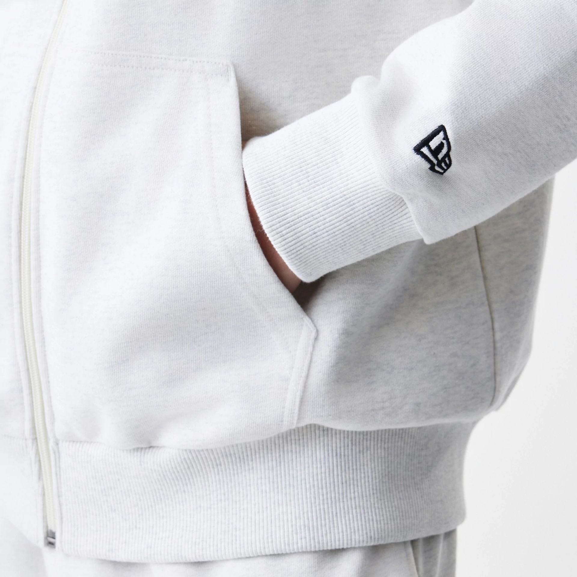 The Male model is wearing New Era Premium Essential Pastel Grey Oversized Full Zip Hoodie 5